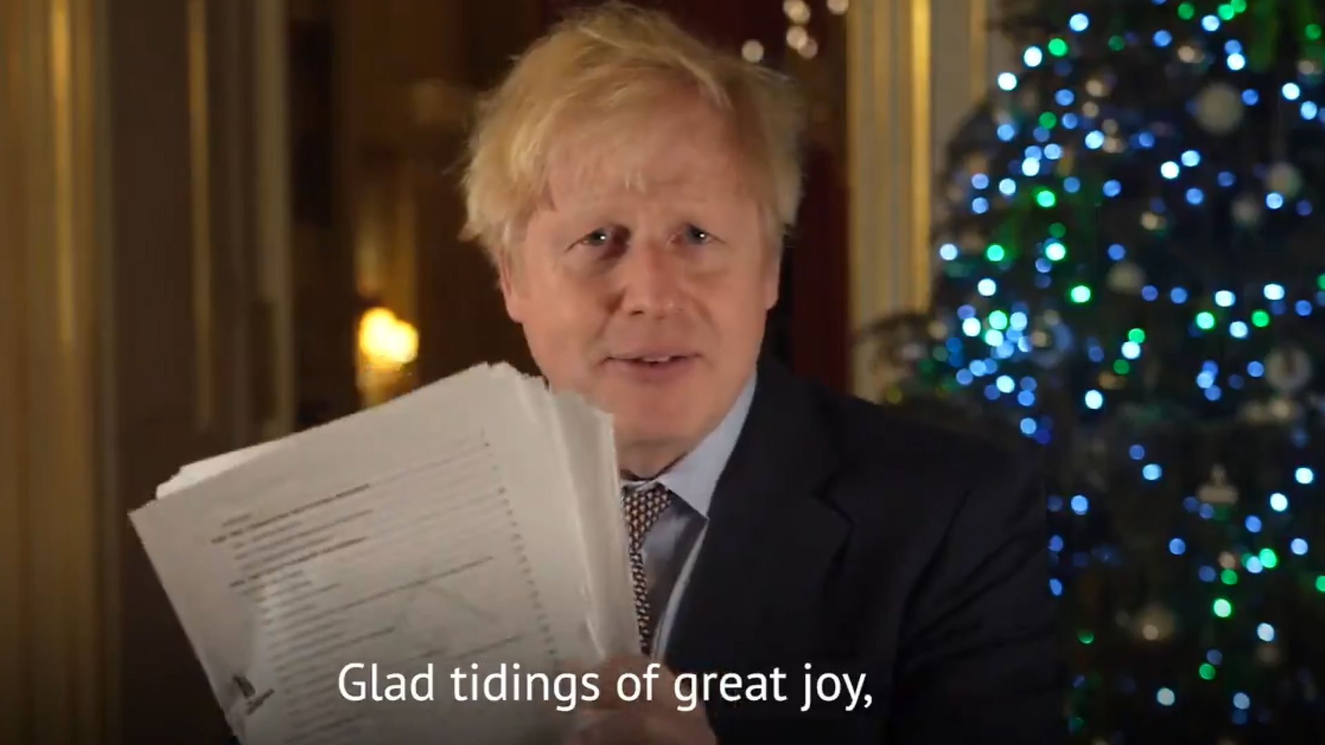 Prime Minister Boris Johnson holding up a document believed to be the pages of the Brexit deal during his Christmas message - Credit: PA