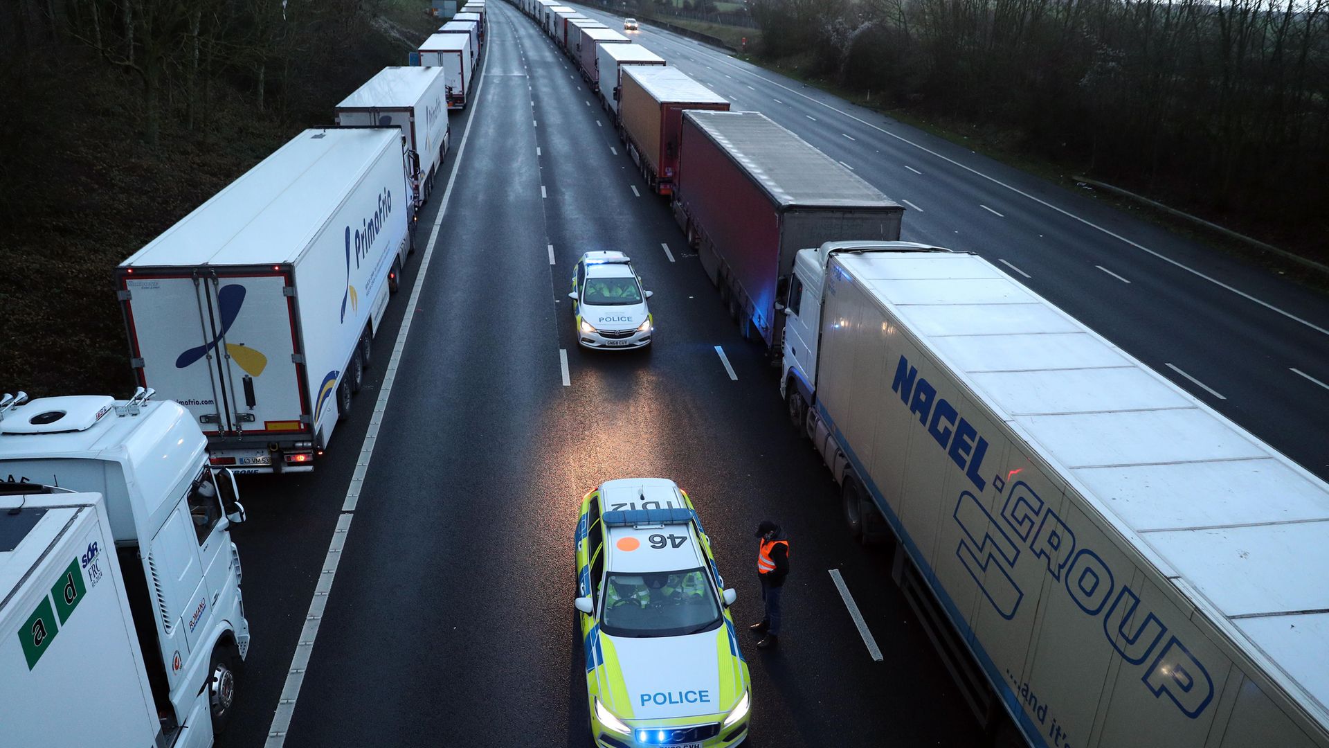 Lorries queue along the M25 in Kent. - Credit: PA