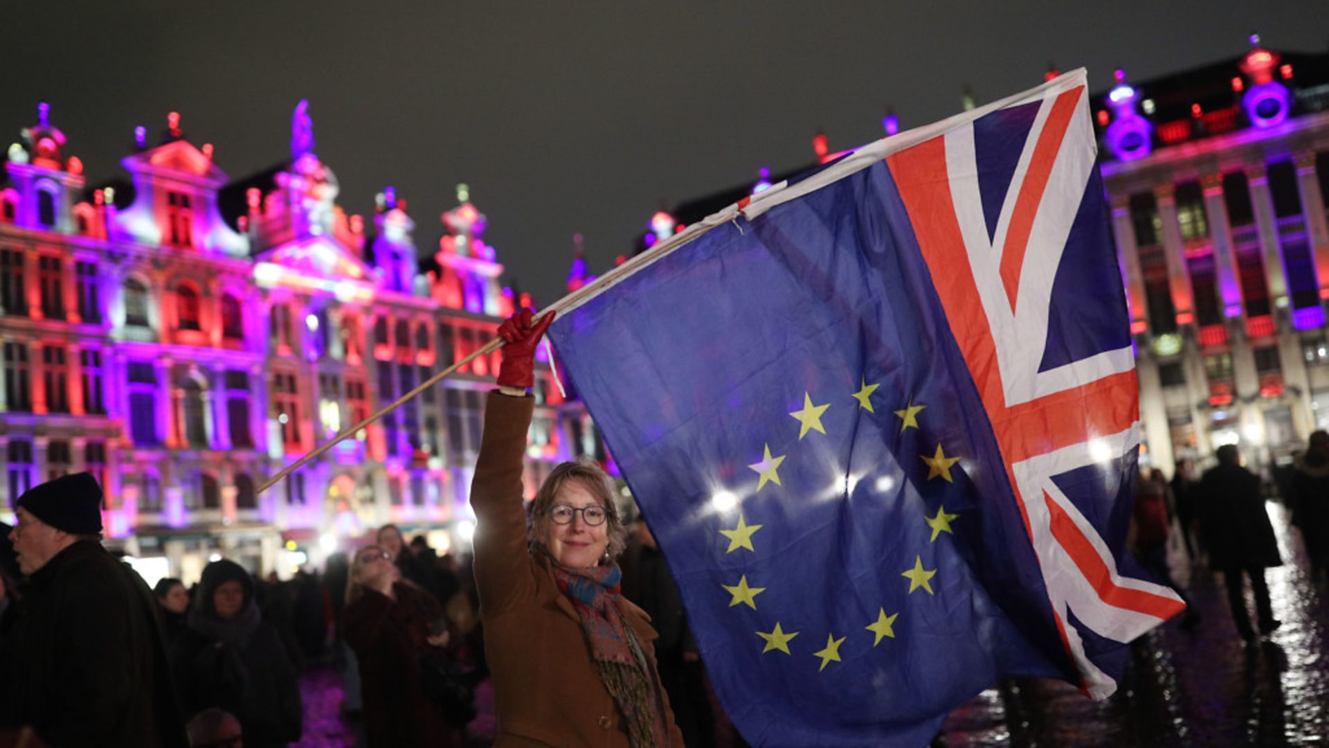 Deirdre Thomas, a resident of Belguim, waving an EU flag and a Union jack in Grand Place in Brussels, Belgium. - Credit: PA