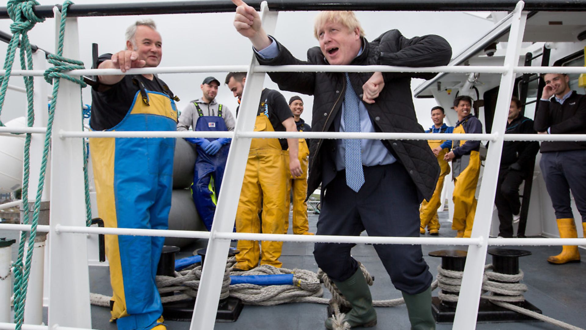 British Prime Minister Boris Johnson speaks to members of the crew on the Carvela at Stromness Harbour, in Scotland. Photo: Robert Perry - WPA Pool/Getty Images) - Credit: Getty Images