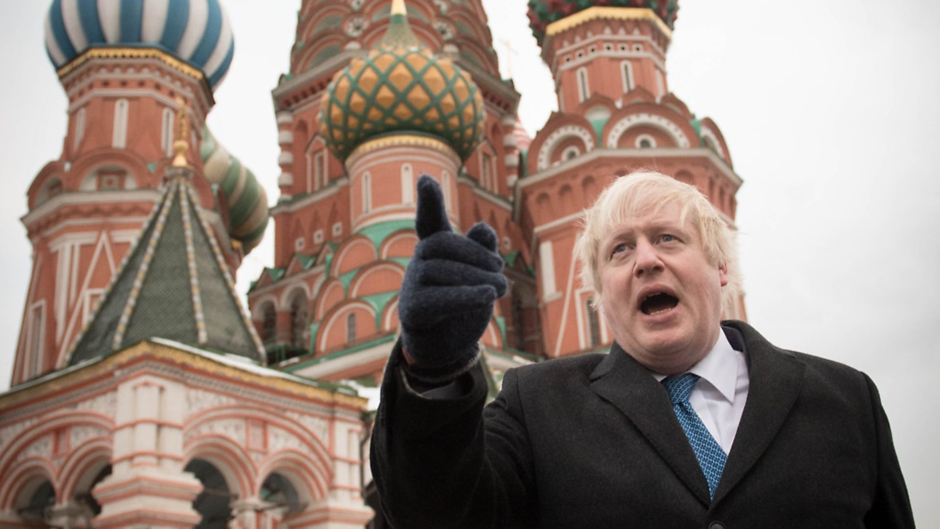 Boris Johnson stands in front of Saint Basil's cathedral in Red square in Moscow. (STEFAN ROUSSEAU/AFP via Getty Images) - Credit: AFP via Getty Images