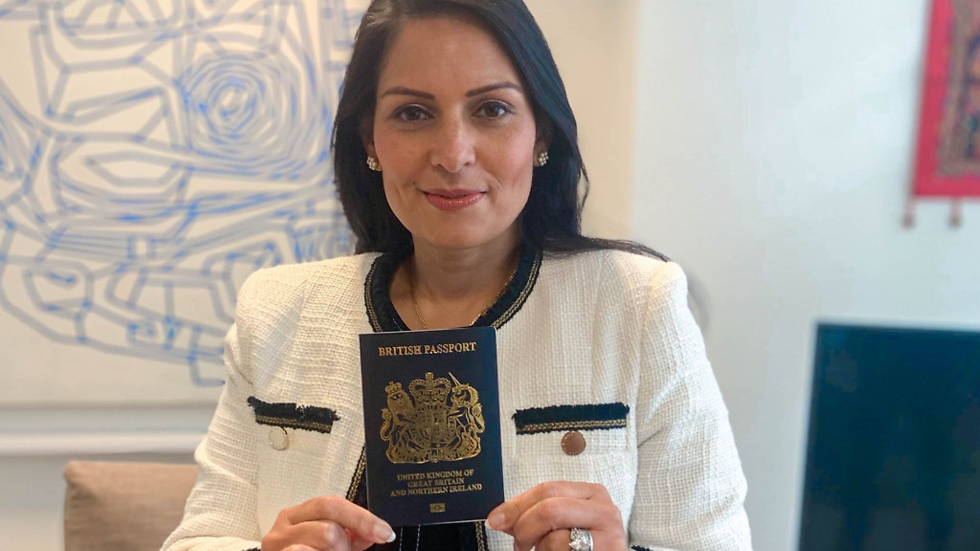 Home Secretary Priti Patel holding a blue passport. Photograph: Home Office/PA Wire. - Credit: PA