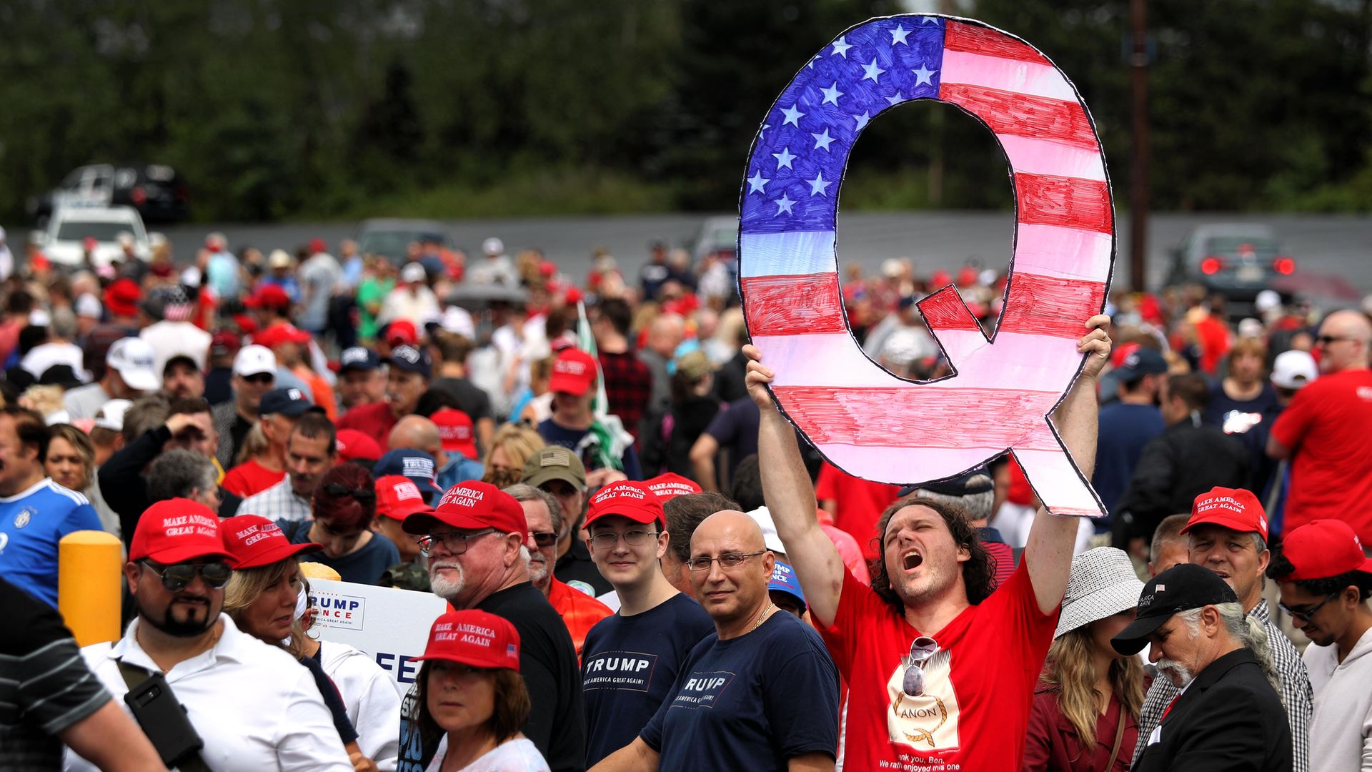 A 'Q' sign, representing QAnon, is held up at a Trump rally in Pennsylvania. The conspiracy theory is the most extreme example of the Age of Belief - Credit: Getty Images