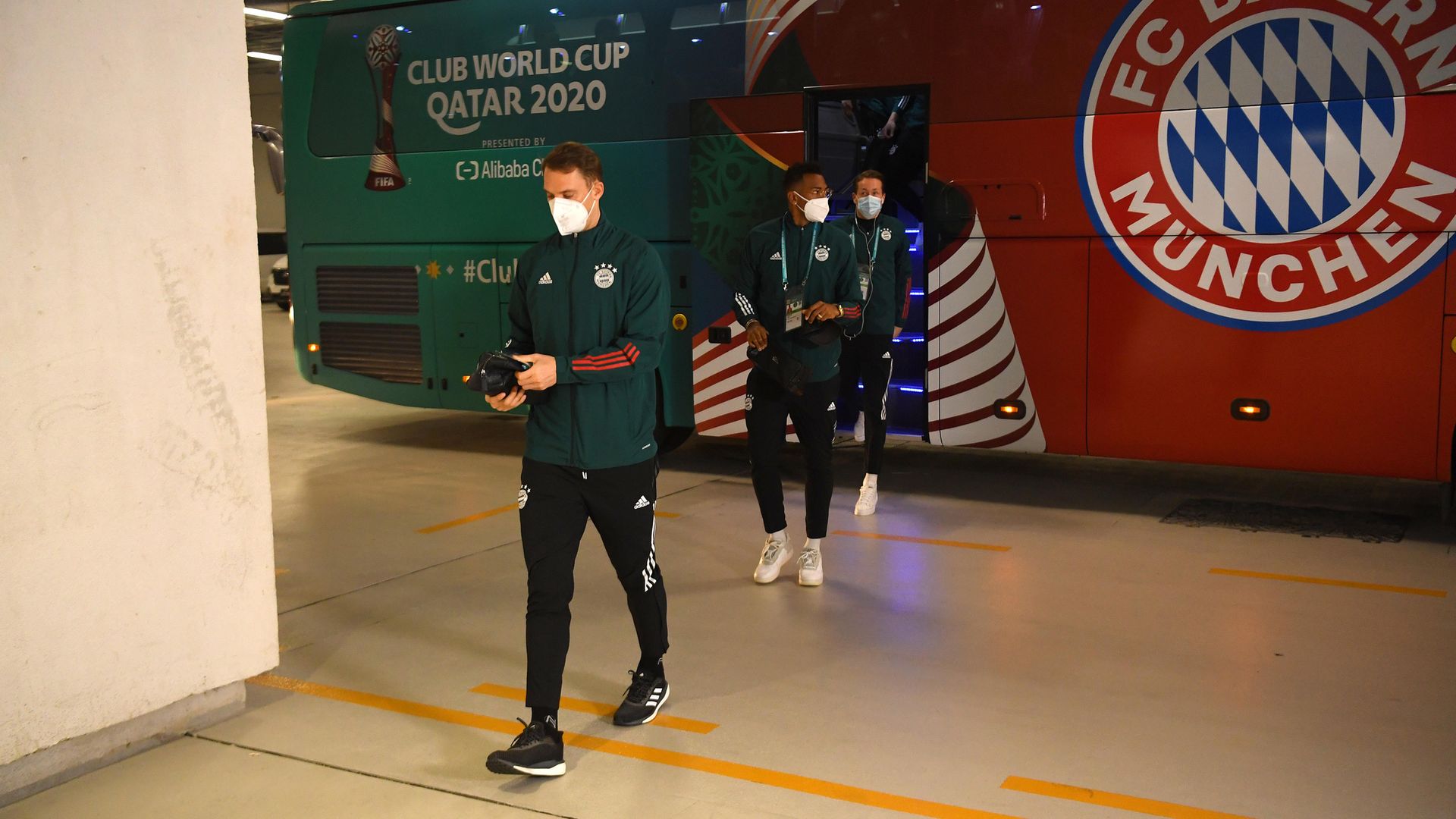 Back on track: Manuel Neuer and Jerome Boateng of Bayern Munich arrive at the stadium prior to the match against Al Ahly at the Ahmad Bin Ali Stadium in Doha, Qatar - Credit: FIFA via Getty Images