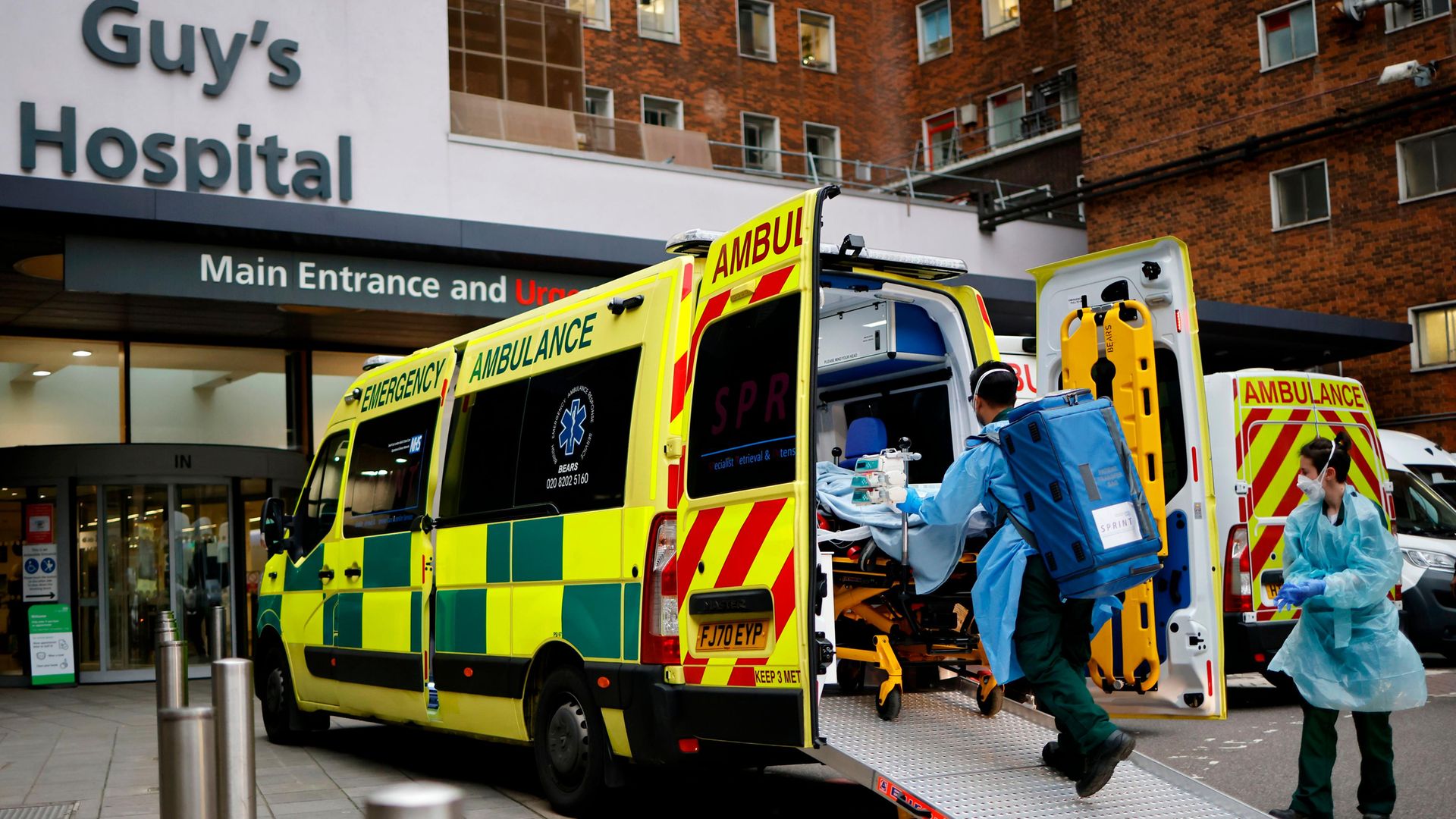 A patient on a gurney is taken from an ambulance parked outside Guy's Hospital in London. Photo: AFP via Getty Images