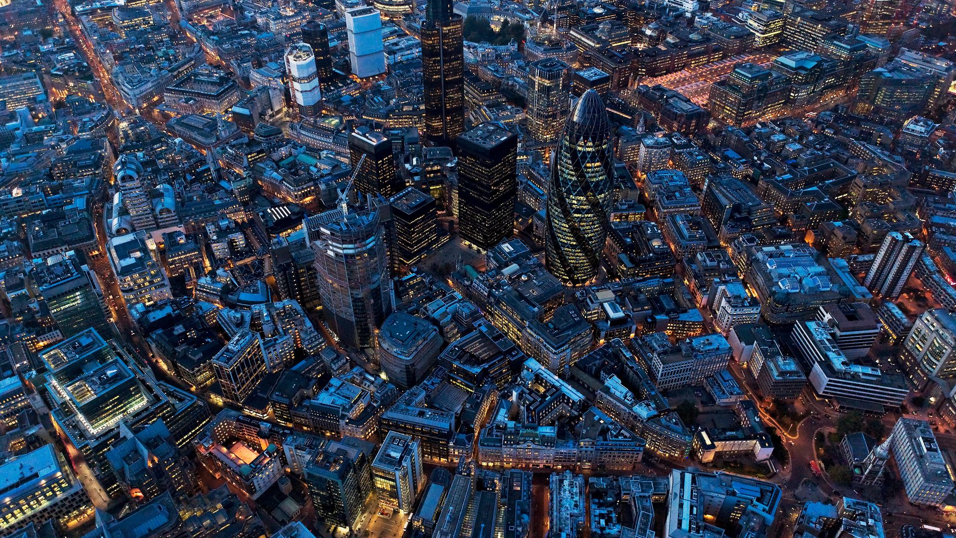 An aerial view of City of London at Night, UK - Credit: Getty Images