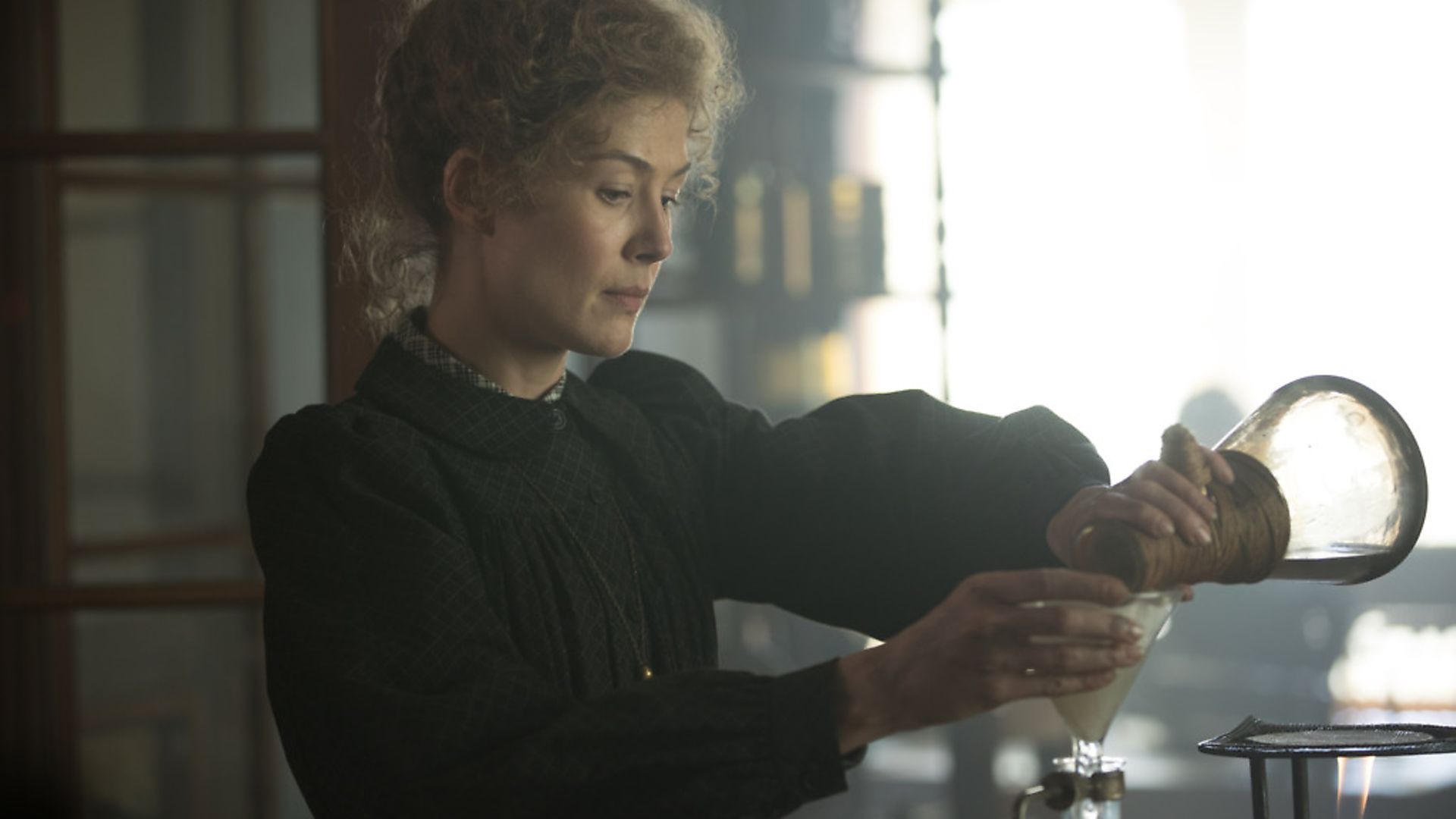 Rosamund Pike as Marie Curie in Radioactive. Photograph: Studio Canal. - Credit: Archant