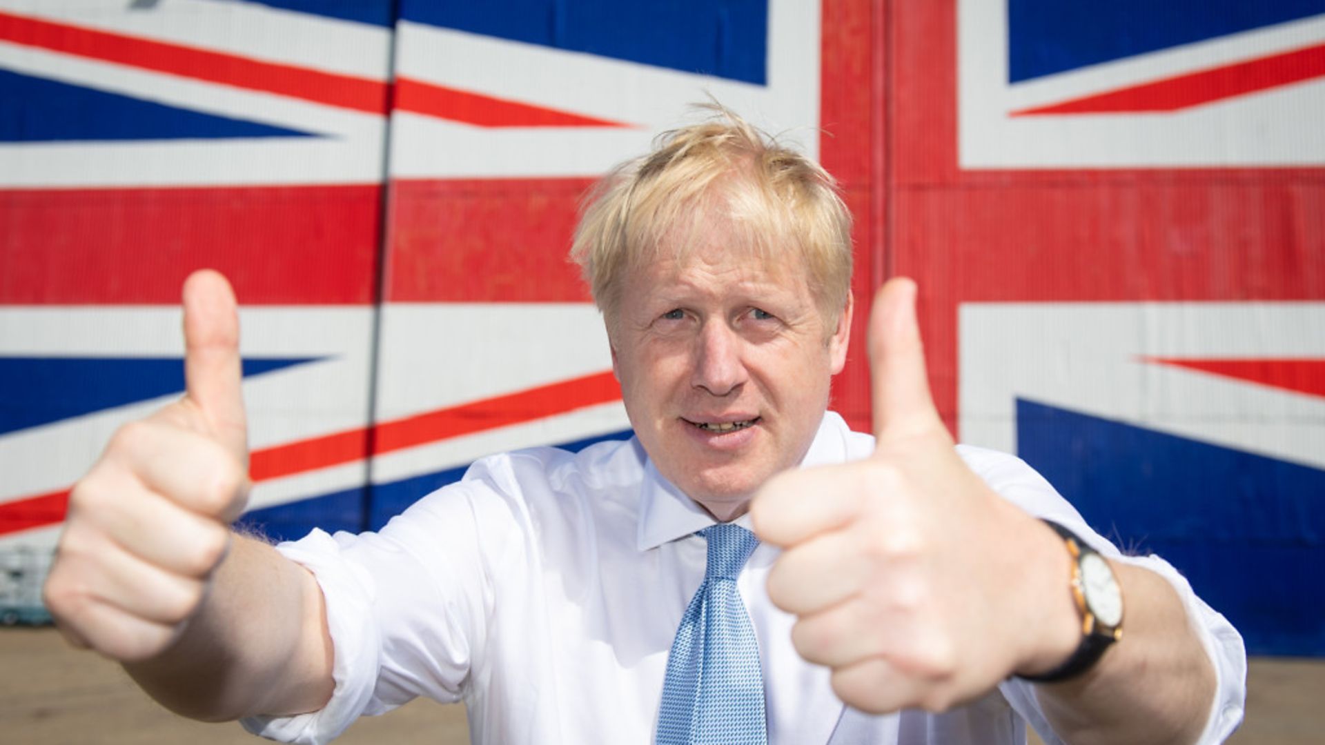 Boris Johnson poses for a 2019 photograph in front of a Union flag - Credit: Getty Images