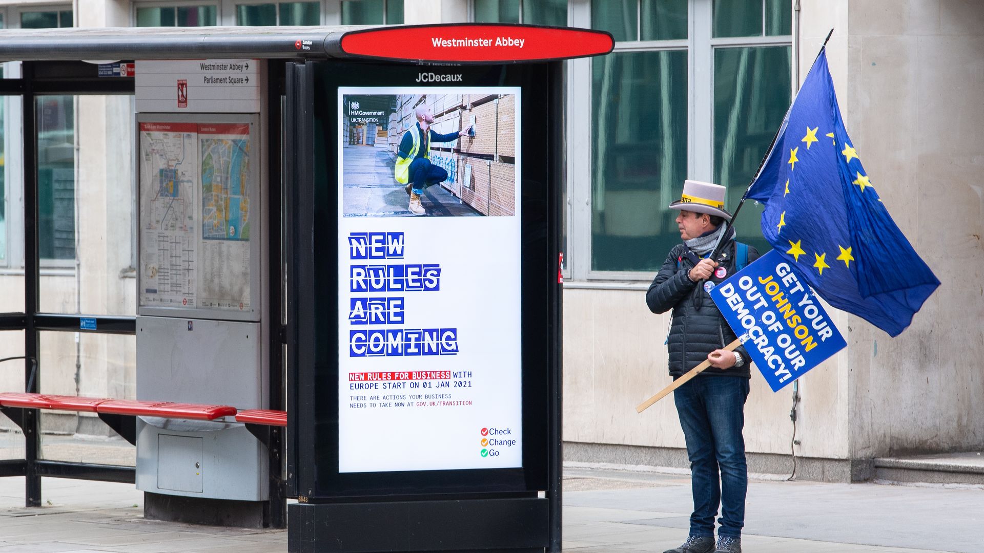 An anti Brexit protestor stands at a bus stop near the Department for Business, Energy and Industrial strategy, in Westminster, London - Credit: PA