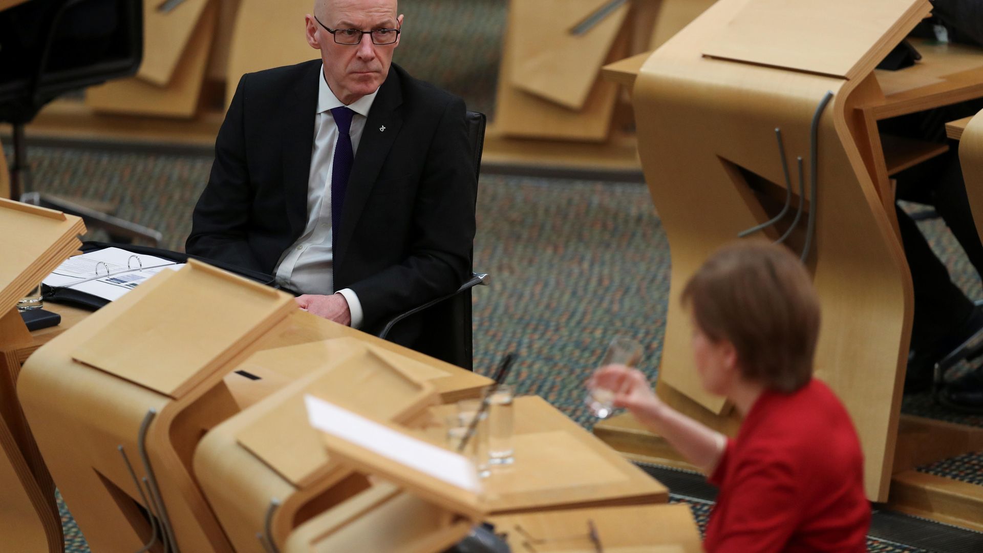 John Swinney (left) listens to First Minister Nicola Sturgeon as she makes a statement to the Scottish Parliament in Holyrood - Credit: PA