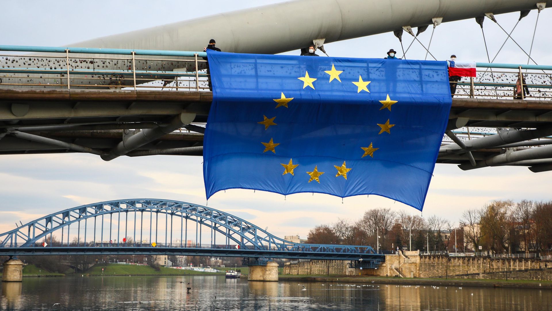 A huge EU flag hung on Father Bernatek footbridge over Vistula River, as part of an anti-government protest organised by the members of the Committee for the Defence of Democracy (KOD) in Krakow, Poland - Credit: NurPhoto via Getty Images