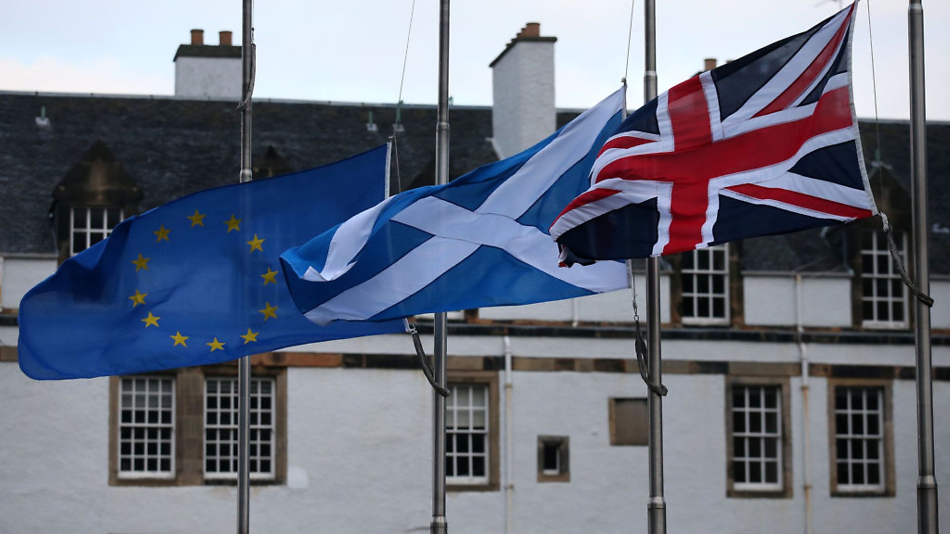 An European Union, a Saltire and an Union flag fly outside the Scottish Parliament in Edinburgh - Credit: PA Archive/PA Images