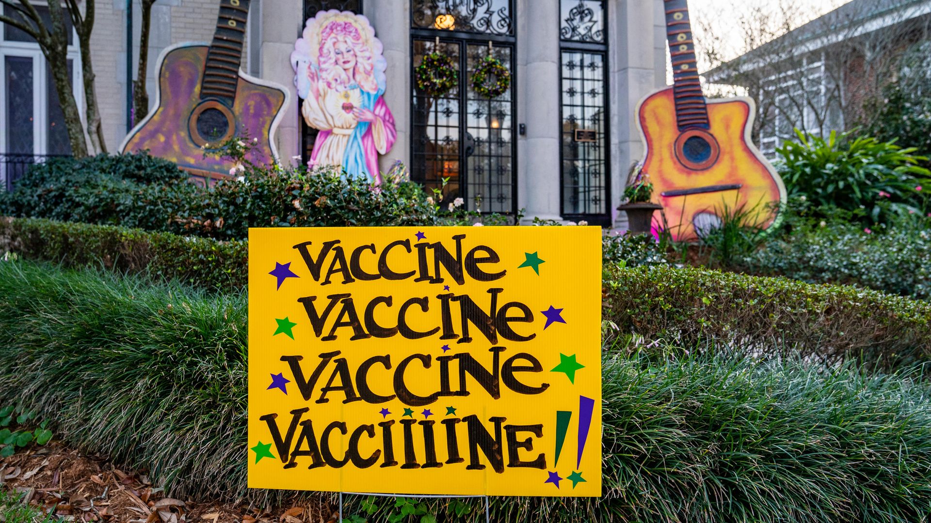 View of a home decorated in honour of Dolly Parton, with a "Vaccine, Vaccine, Vaccine, Vacciiiine!!!" sign meant to evoke the lyrics of Parton's song "Jolene" on January 28, 2021 in New Orleans, Louisiana. Due to the COVID-19 pandemic cancelling traditional Mardi Gras activities, New Orleanians are decorating their homes and businesses to resemble Mardi Gras floats. - Credit: Getty Images