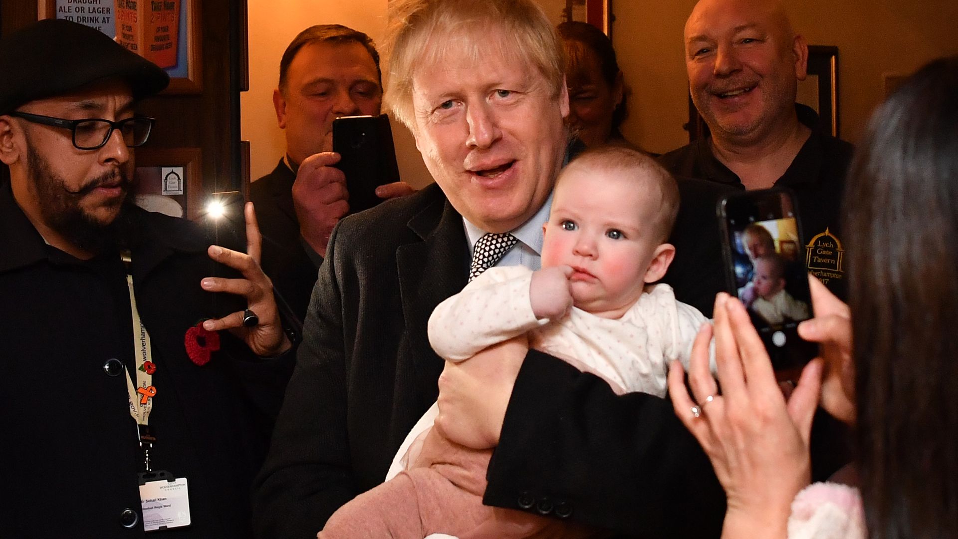 Boris Johnson holds a baby as he meets supporters as he campaigns ahead of the general election - Credit: Ben Stansall/WPA Pool/Getty Images