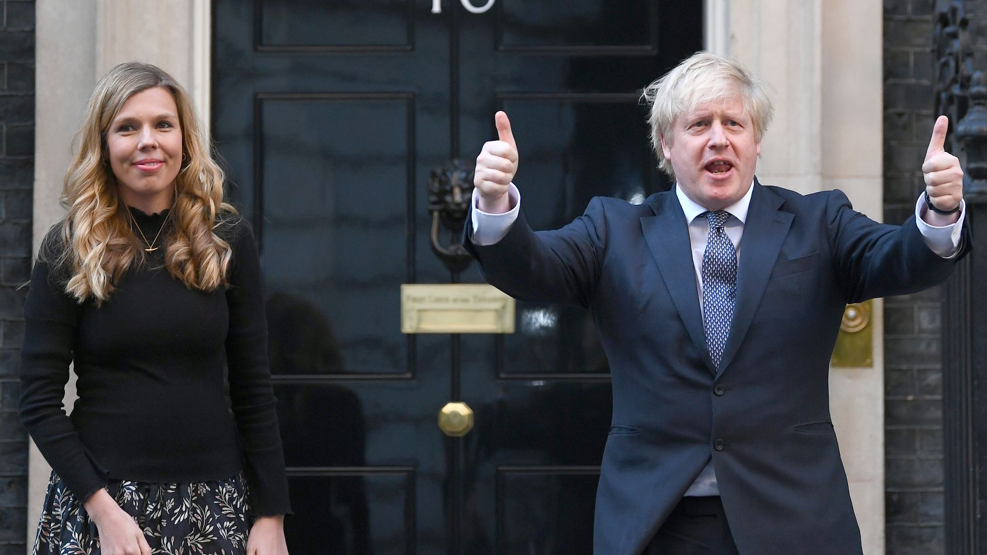 Prime minister Boris Johnson and his partner Carrie Symonds, stand in Downing Street, London - Credit: PA