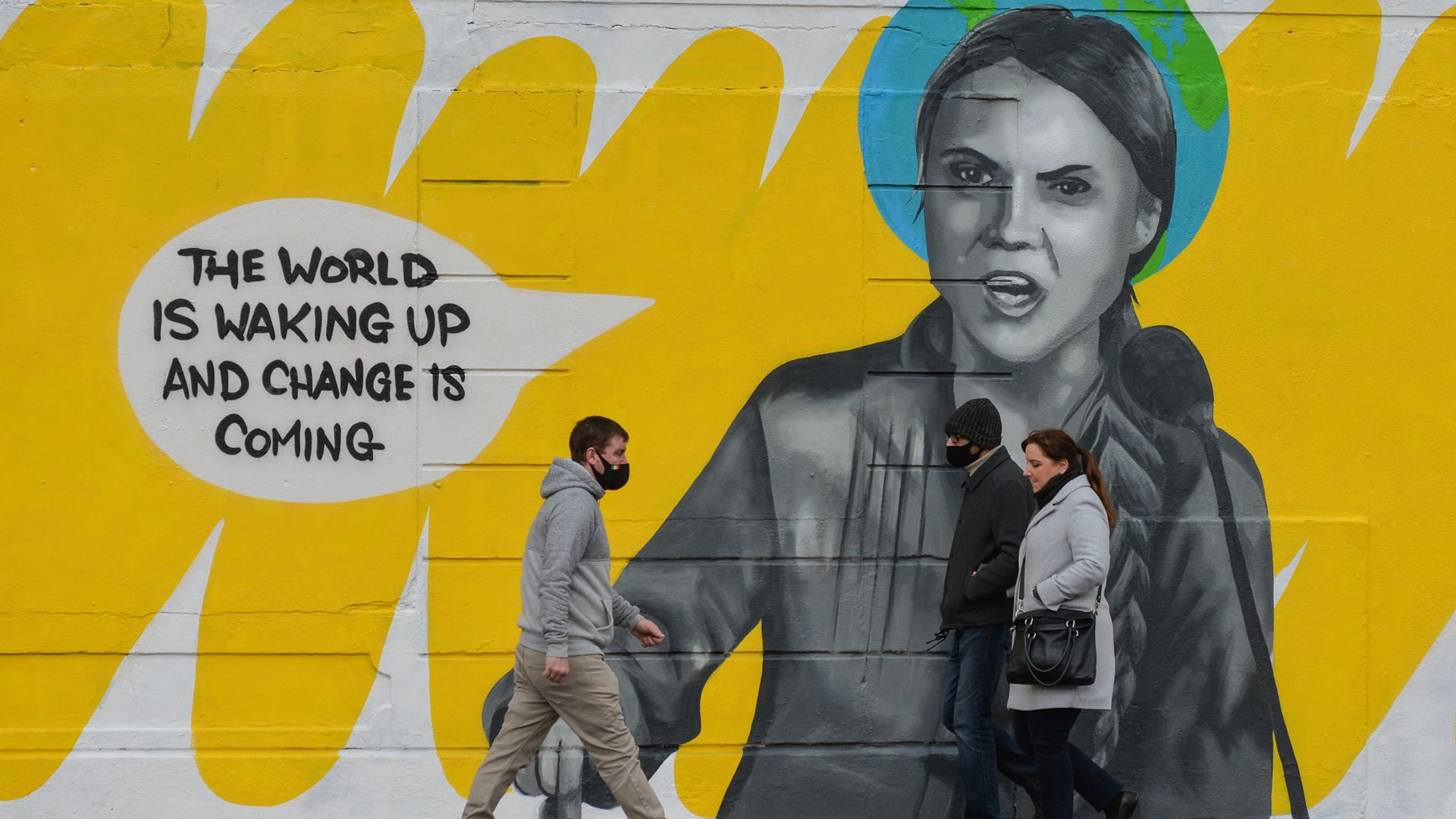 People walk by a mural in Dublin city centre of Swedish environmental activist Greta Thunberg. Photo: NurPhoto via Getty Images