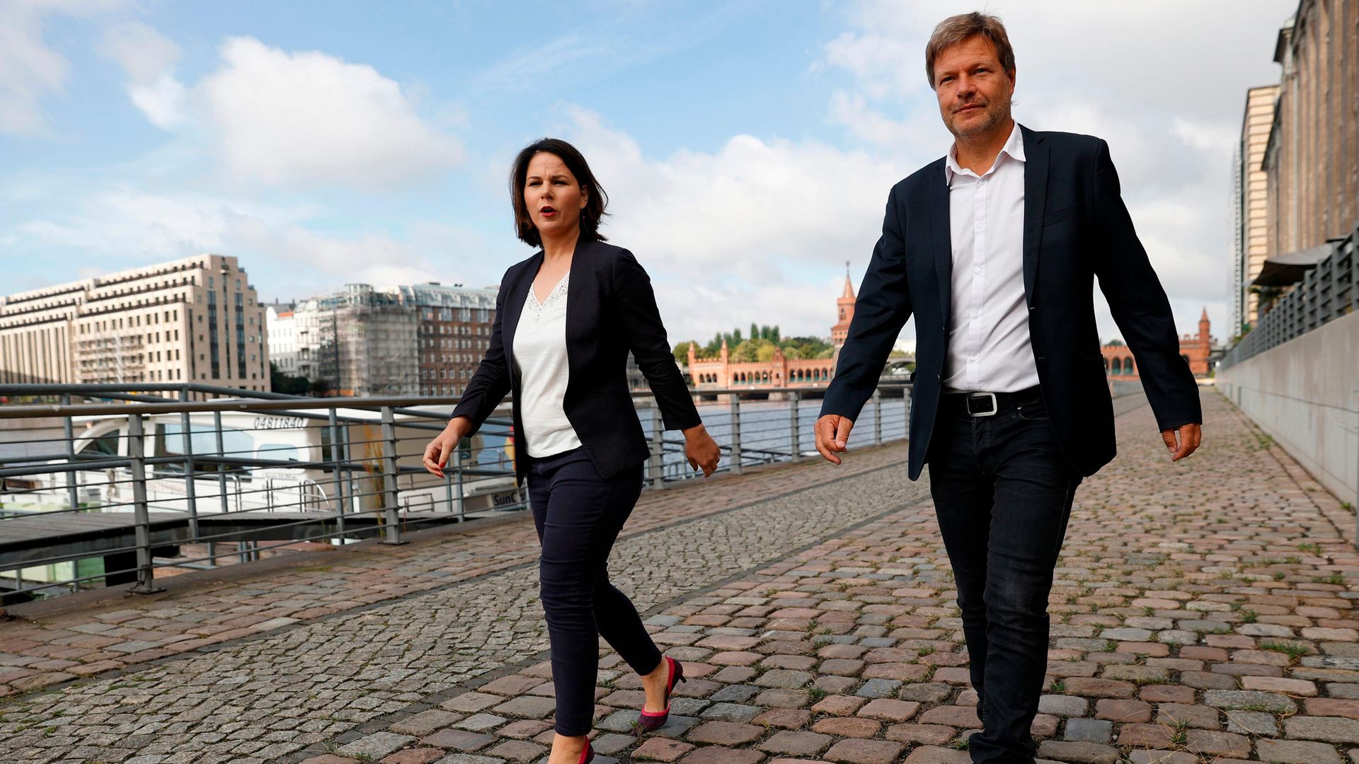 Co-leaders of Germany's Green Party Annalena Baerbock and Robert Habeck walk along Berlin's river Spree - Credit: AFP via Getty Images