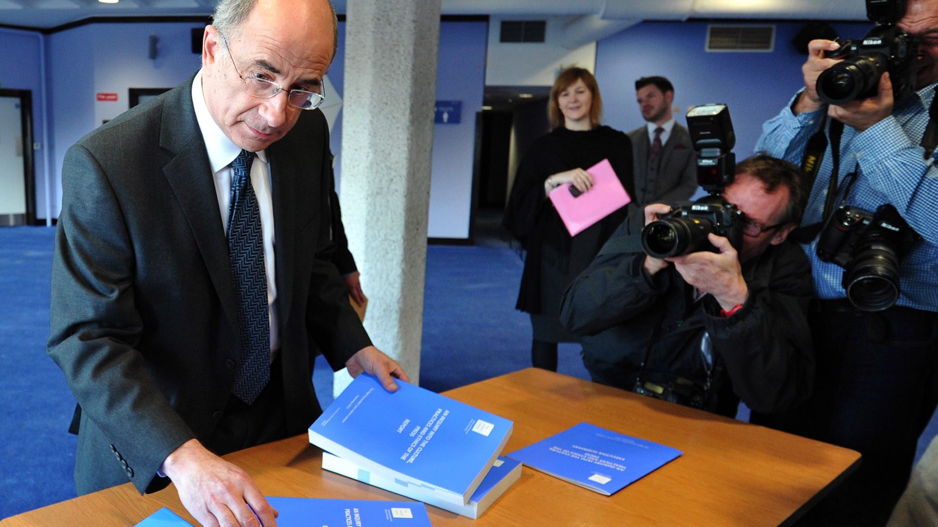 Lord Justice Leveson arranges copies of the Summary of the Leveson Report. Photo: Carl Court/AFP via Getty Images - Credit: AFP via Getty Images