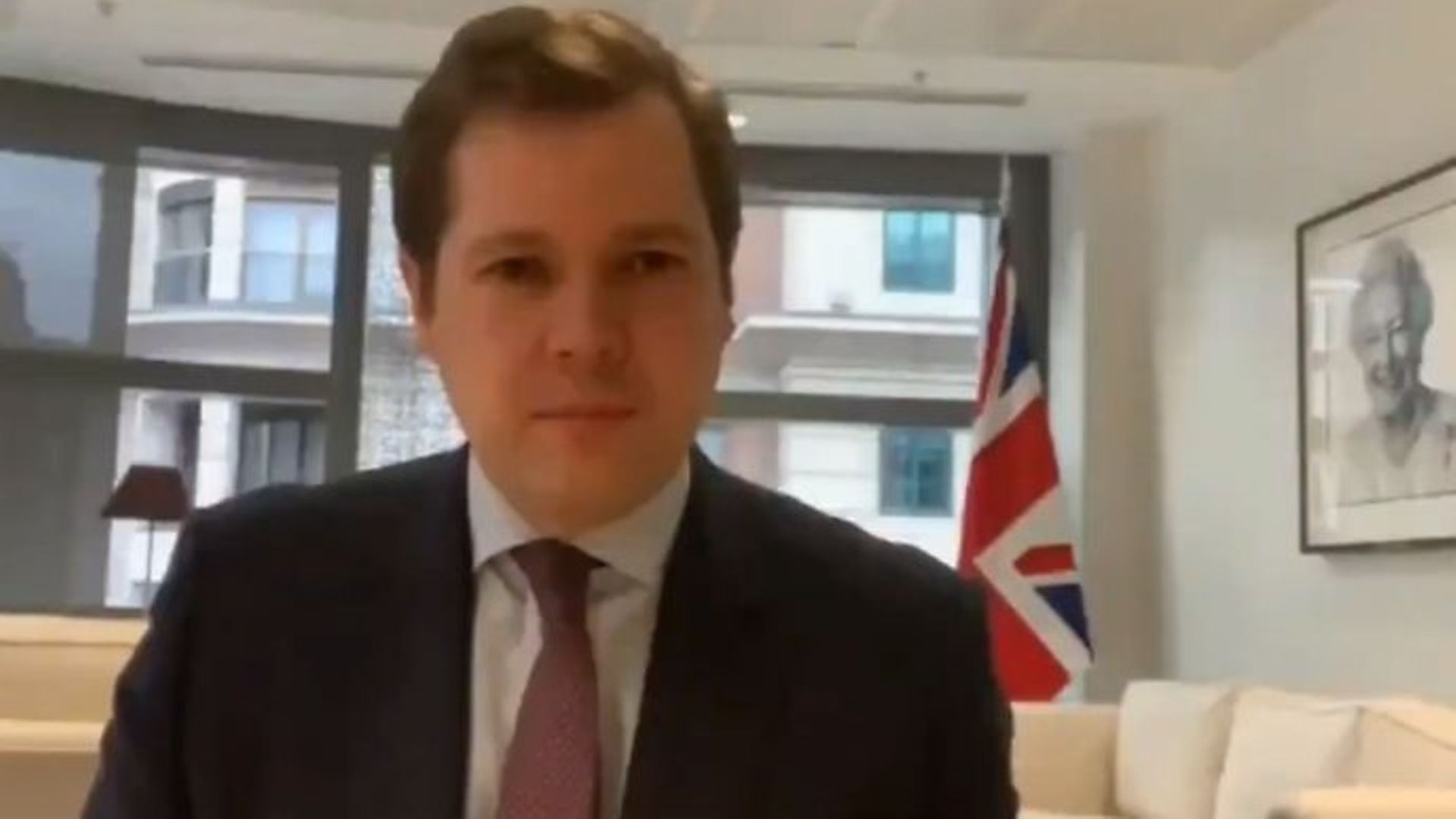 Robert Jenrick was mocked by BBC presenters over the size of the Union flag (pictured above) in his office during an interview - Credit: BBC