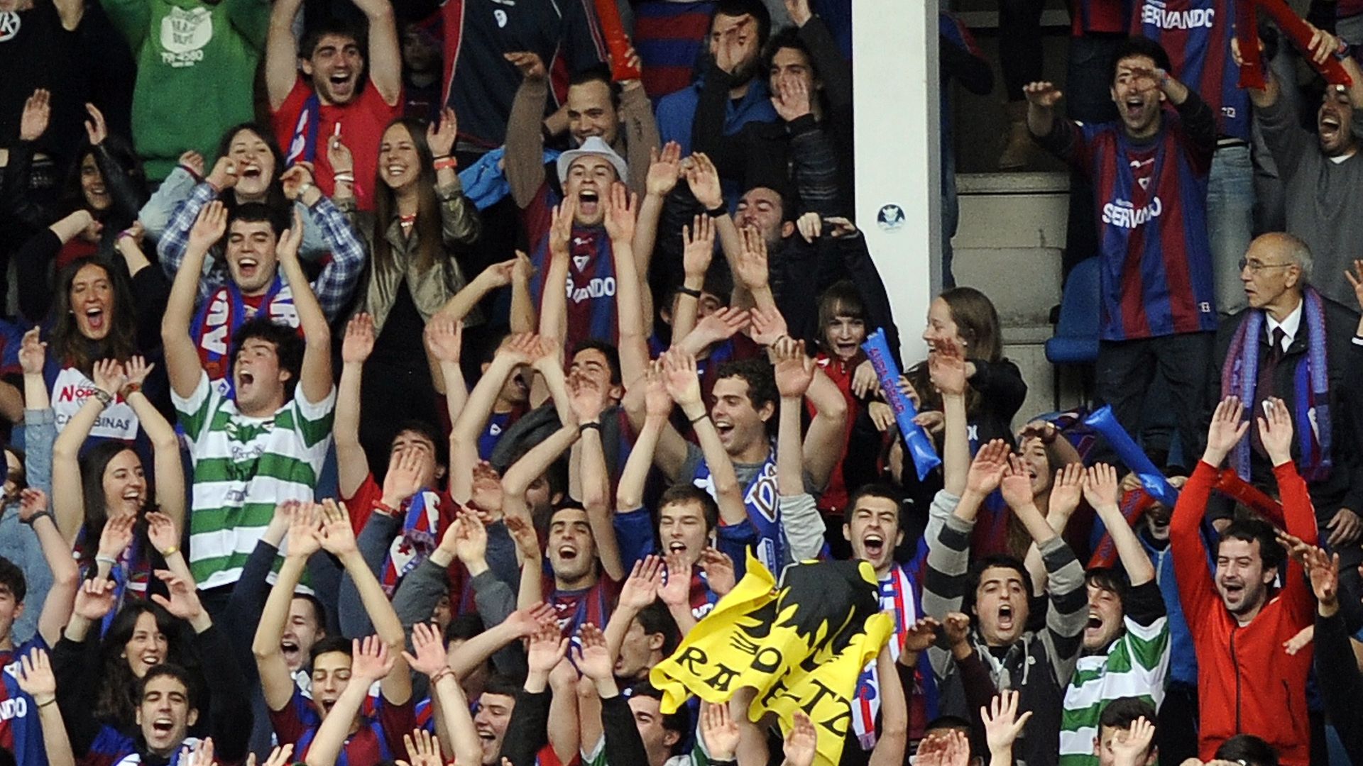 Basque flags and Celtic shirts can be seen as Eibar's fans celebrate during the team's promotion campaign in 2014 - Credit: AFP via Getty Images