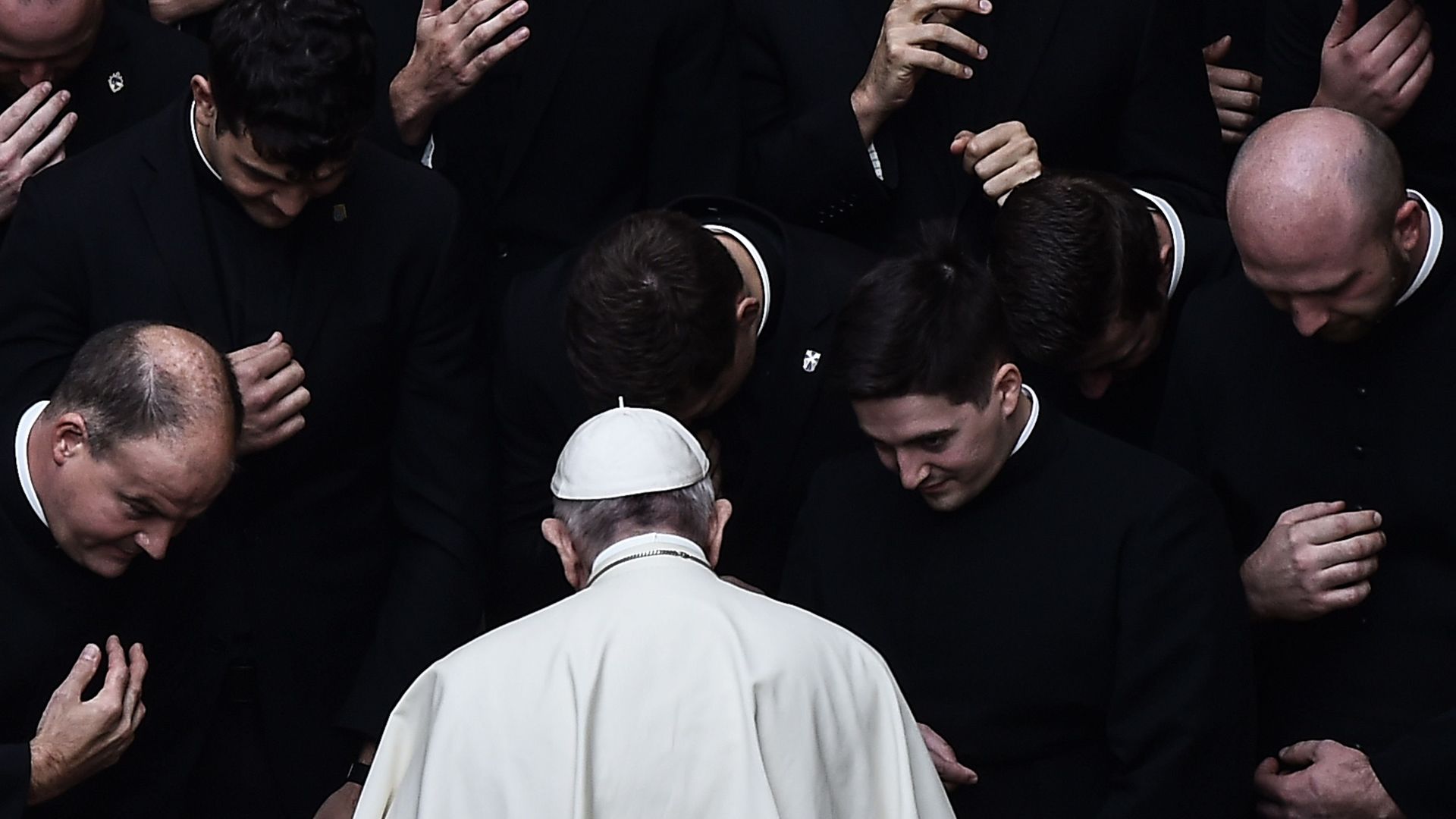 Pope Francis prays with priests at the end of a limited public audience at the San Damaso courtyard in The Vatican. Photo: AFP via Getty Images