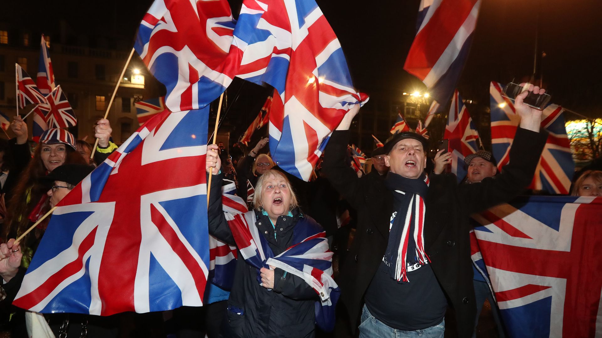 Pro-Brexit supporters gather in George Square, Glasgow, as the UK prepared to leave the European Union on January 31 last year - Credit: PA