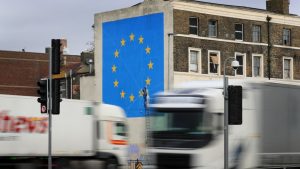 Lorries pass the Brexit-inspired mural by artist Banksy in Dover. Photo: PA Wire/PA Images.