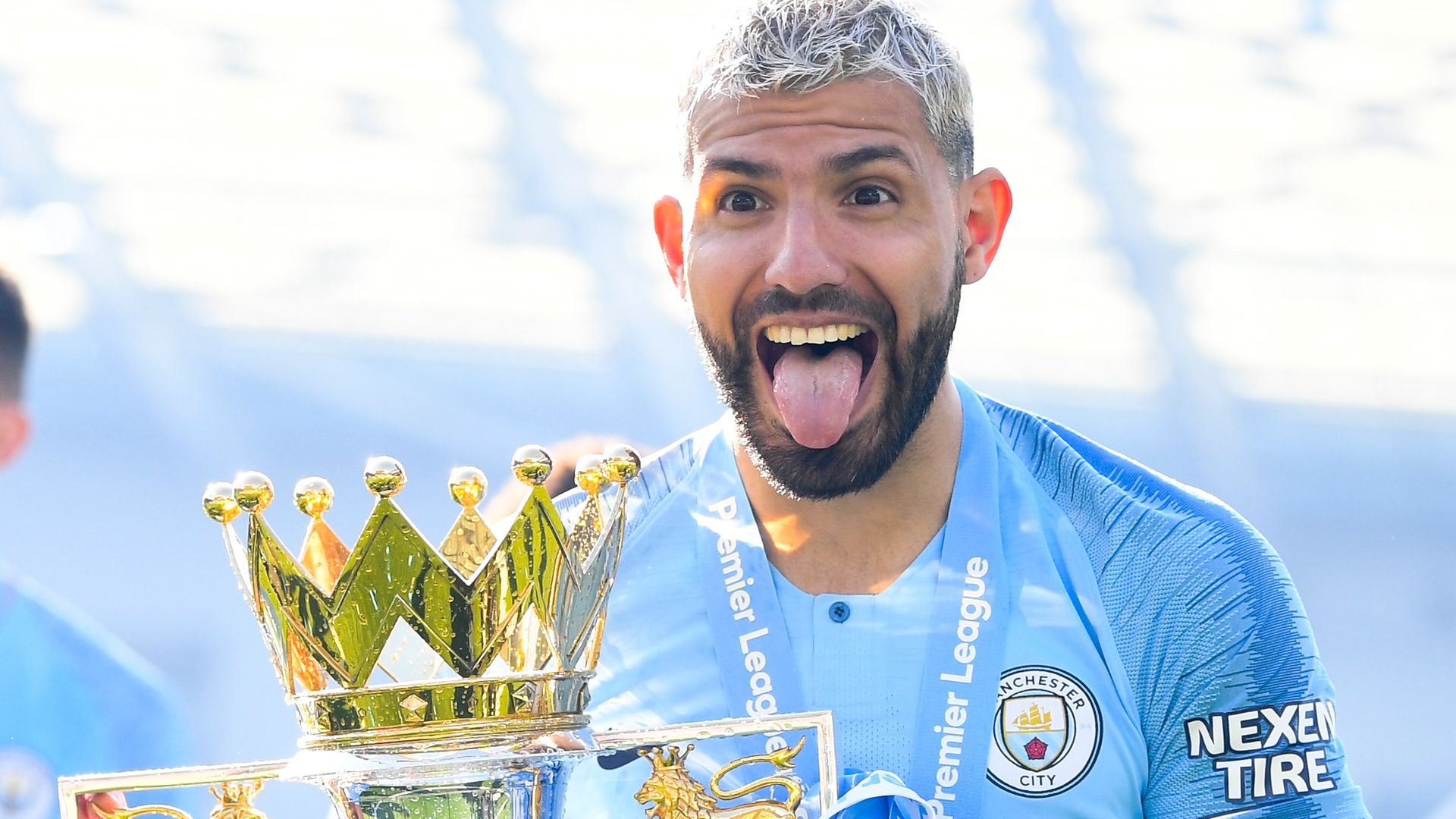 Sergio Aguero celebrates with the Premier League trophy after Manchester City clinched the Premier League title by beating Brighton on May 12, 2019 - Credit: Photo by Michael Regan/Getty Images