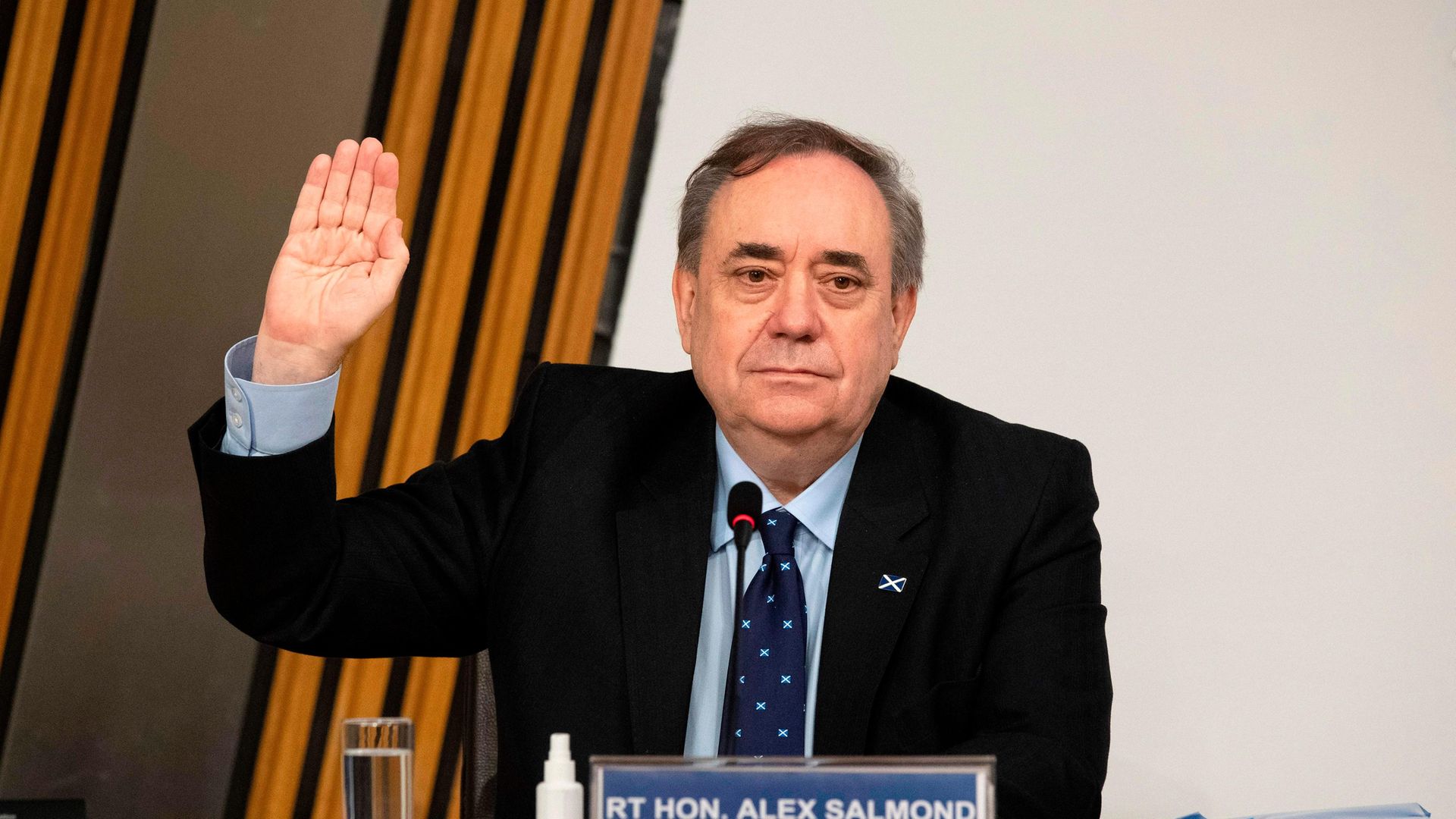 Former SNP leader and former first minister of Scotland Alex Salmond is sworn in before giving his evidence to the Holyrood committee investigating the handling of harassment allegations against him - Credit: POOL/AFP via Getty Images