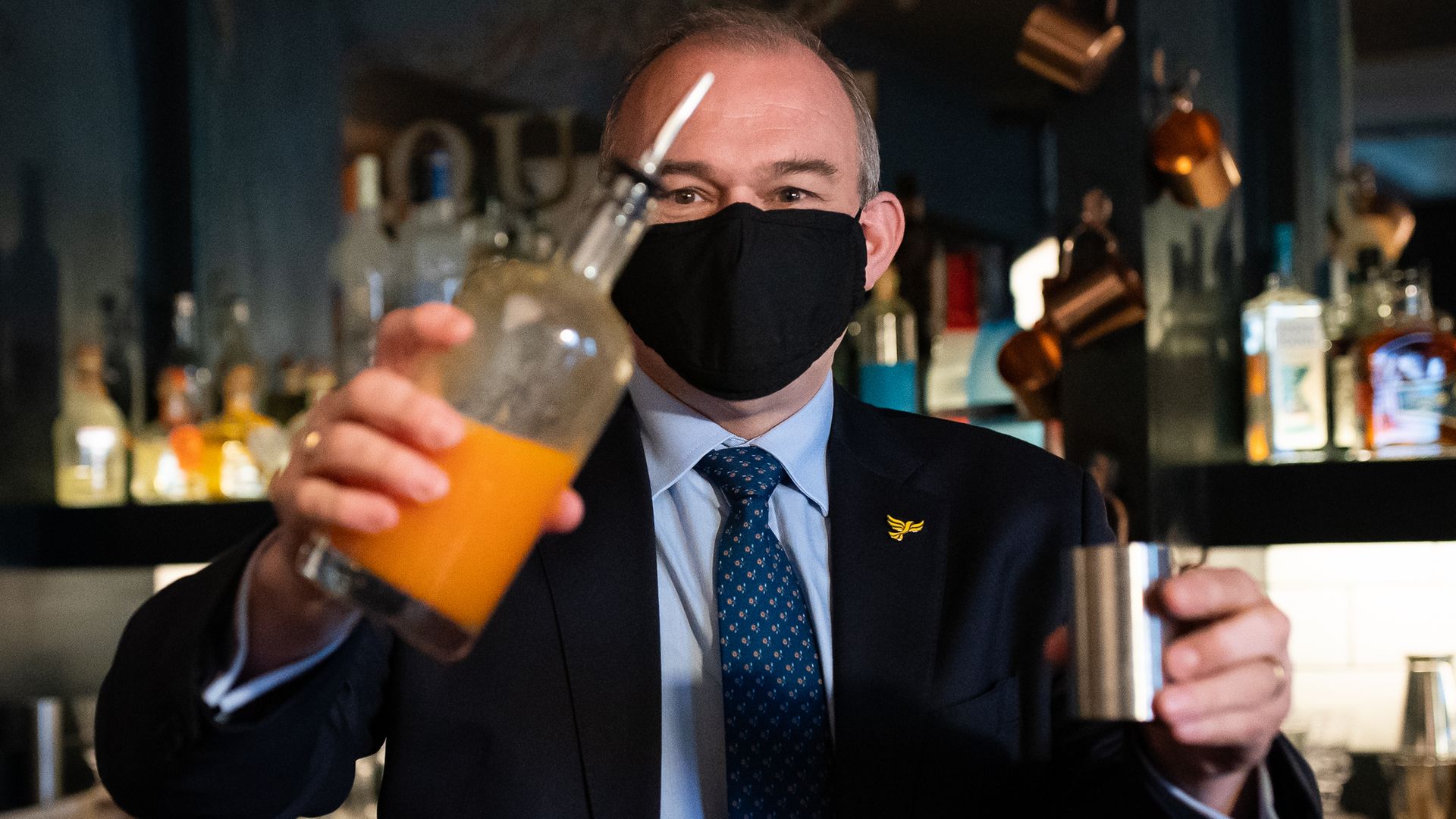 Liberal Democrats leader Sir Ed Davey tries his hand at cocktail making during a visit to Bar Bodega in Watford - Credit: PA