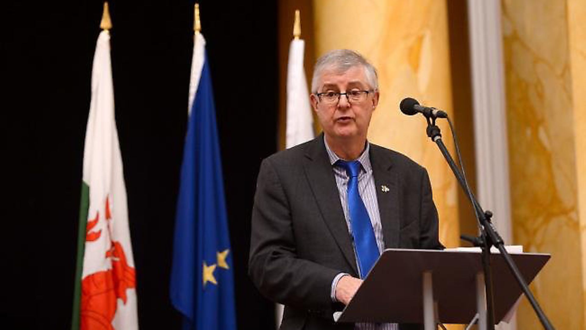 Mark Drakeford appears in front of a European flag. Photograph: CPMR/Flickr. - Credit: Archant