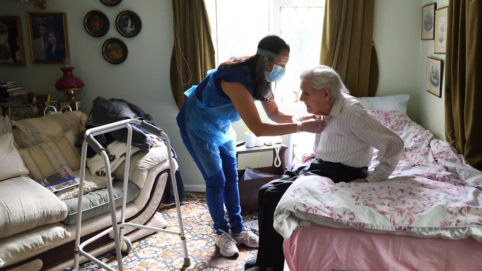 Careworker Fabiana Connors visits client Jack Hornsby at his home during the coronavirus pandemic in Elstree, England. Fabiana Connors continues to work during the coronavirus pandemic, visiting clients in their own homes to help with daily personal care routines. Photo: Karwai Tang/Getty Images - Credit: Getty Images