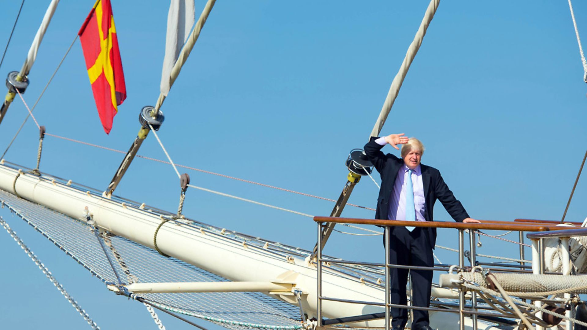 Boris Johnson salutes from the deck of a tall ship. Photograph: Dominic Lipinski/PA. - Credit: PA
