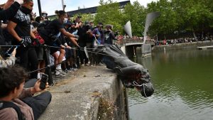 Protesters throw statue of Edward Colston into Bristol harbour during a Black Lives Matter protest rally. Photo: Ben Birchall/PA Wire. - Credit: PA