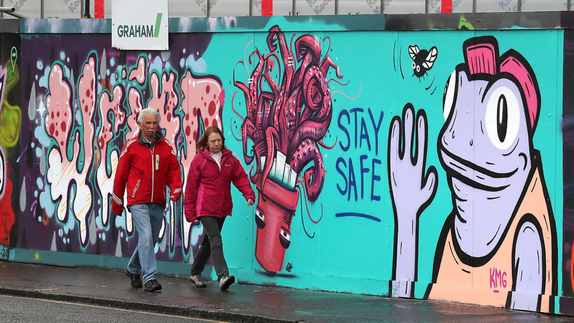 People walk past coronavirus related graffiti in Edinburgh. Photograph: Andrew Milligan/PA Wire. - Credit: PA
