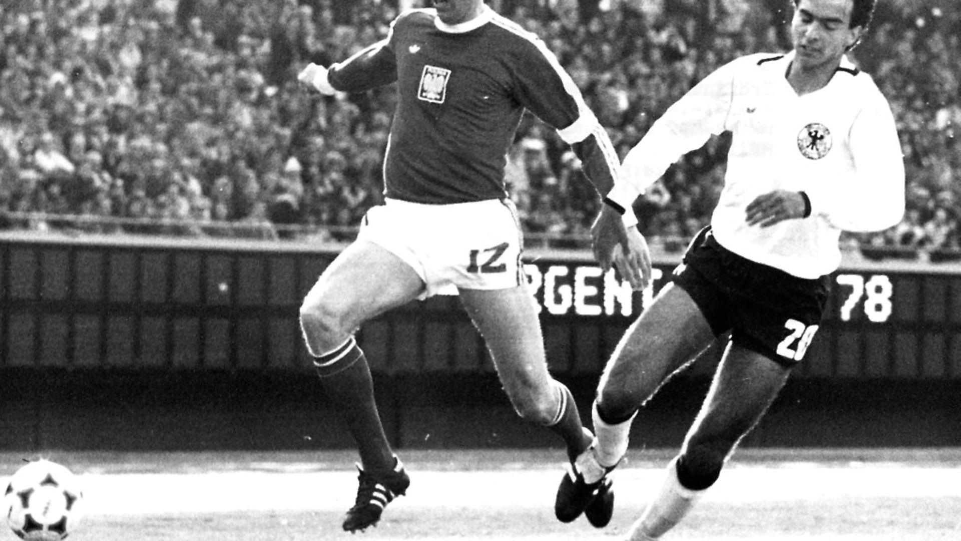 Poland's Kazimierz Deyna, left, skips past Germany's Hansi Mueller in a 0-0 draw at the 1978 FIFA world cup in Argentina. Picture: Getty Images - Credit: ullstein bild via Getty Images