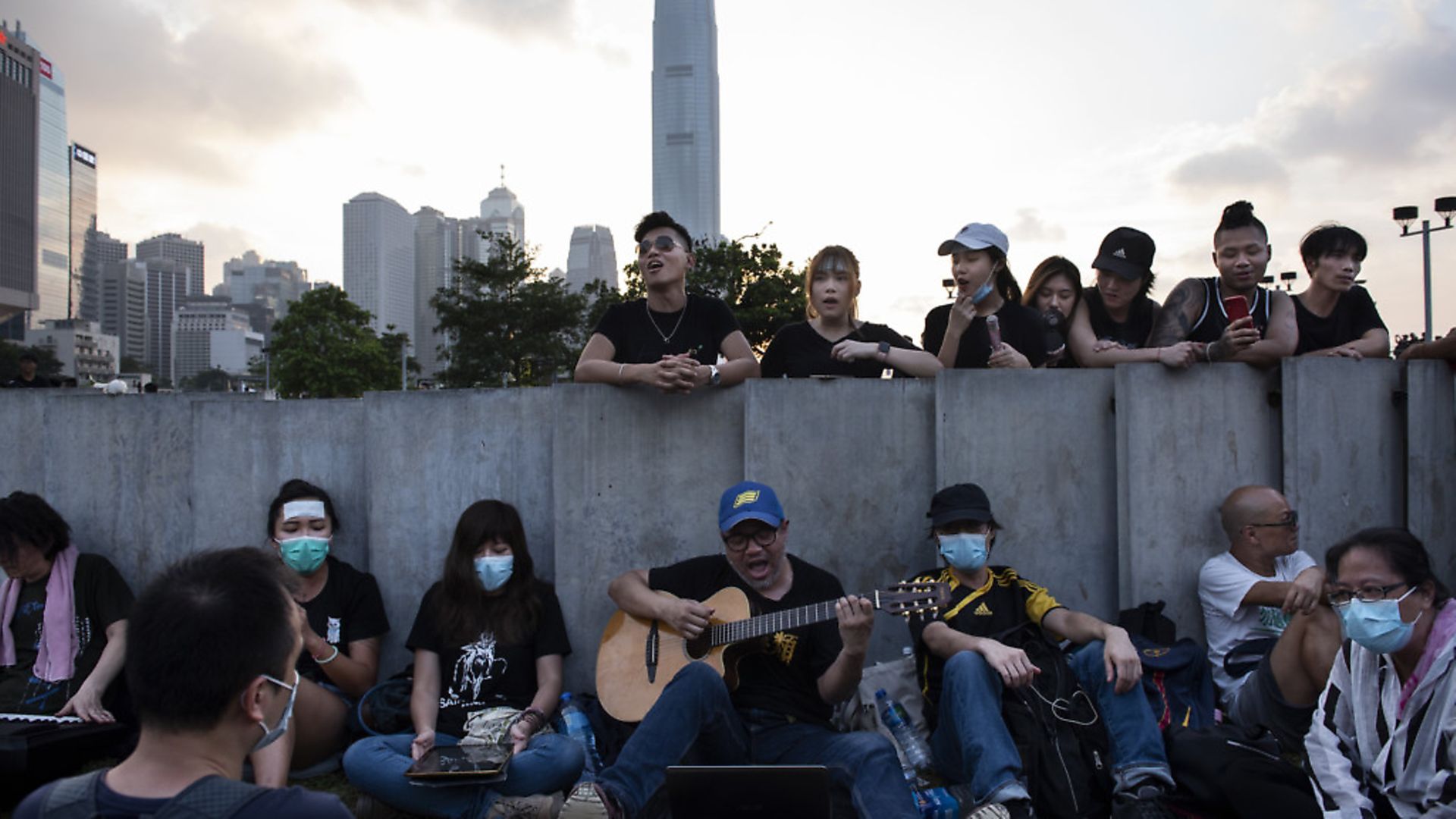 Protesters gather near Hong Kong's Legislative Council Complex singing encouraging songs to support the movement and mass rally.  Photo: Miguel Candela/SOPA Images/LightRocket via Getty Images - Credit: LightRocket via Getty Images