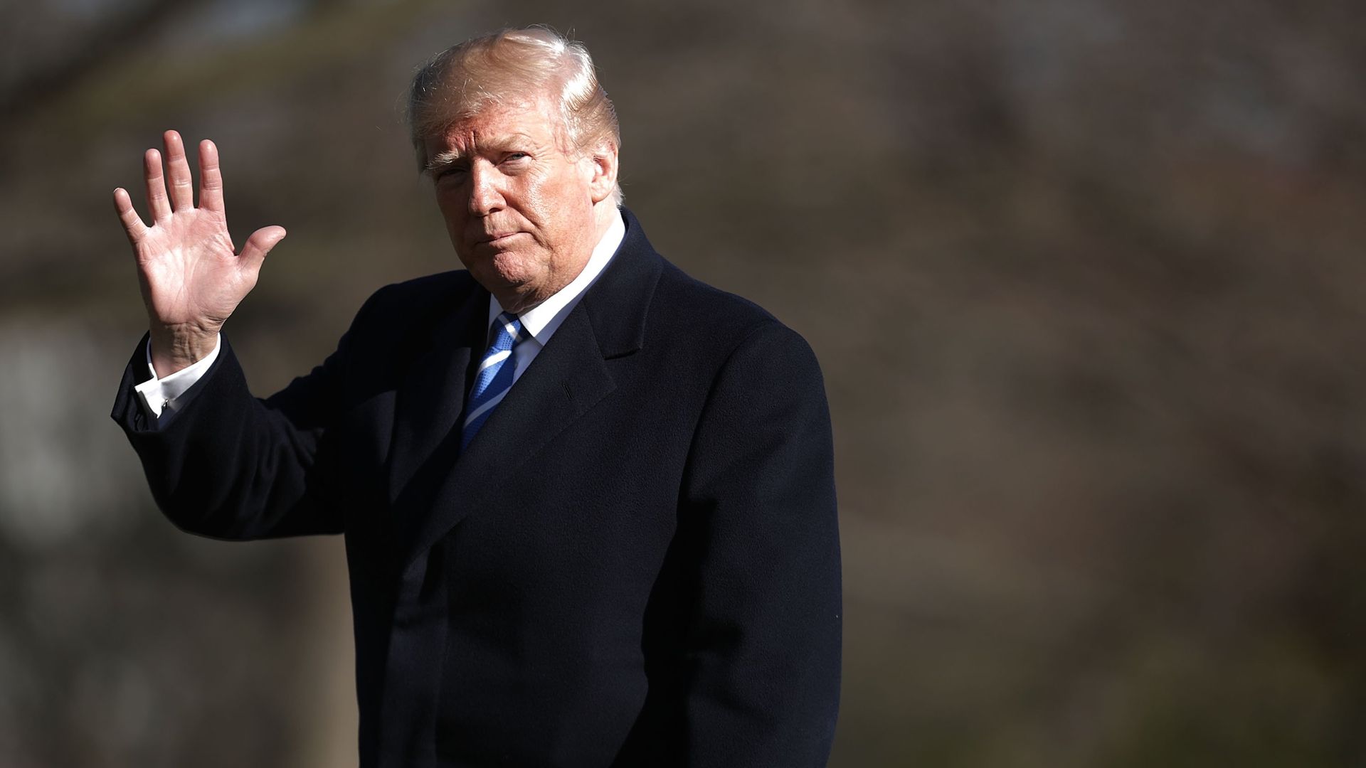 U.S. President Donald Trump waves to journalists - Credit: Getty Images