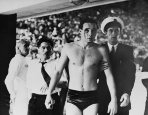 Ervin Zador is escorted from the pool, with blood pouring from a wound inflicted by a Russian opponent.