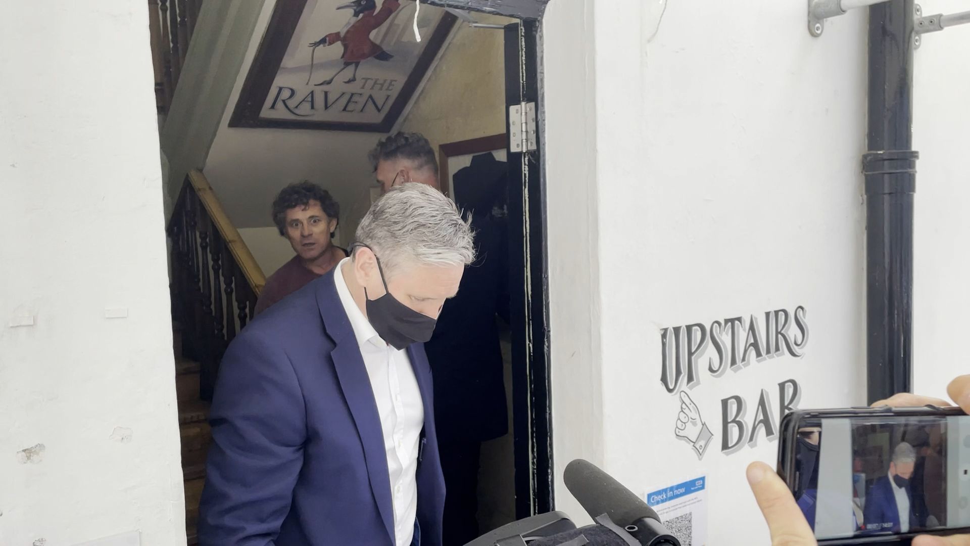 Rod Humphris (back left) landlord of the Raven pub refuses entry to Labour leader Sir Keir Starmer (front) during his visit to Bath - Credit: PA