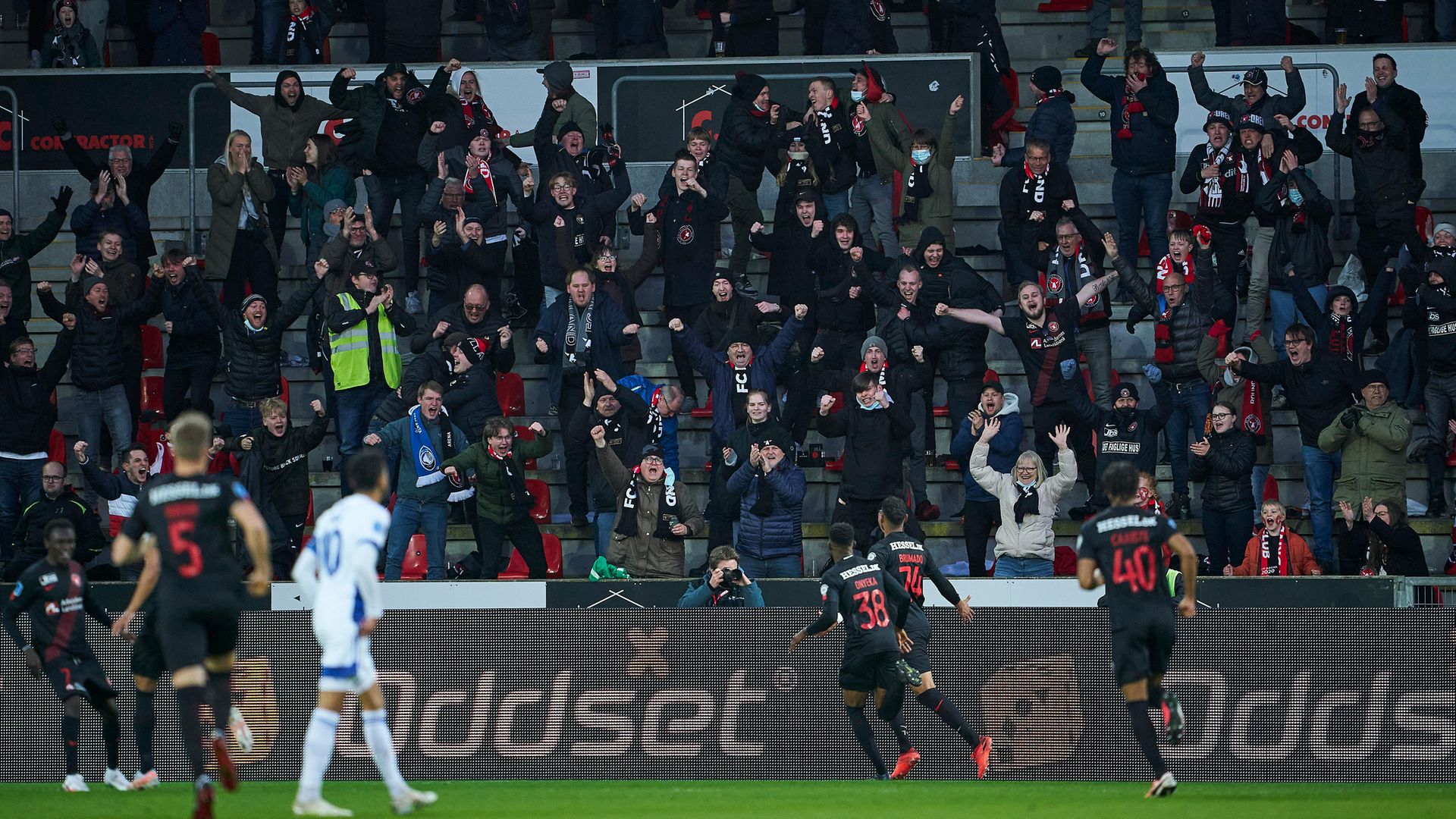 UNFAMILIAR SIGHT: FC Midtjylland fans react as their team goes 1-0 up against  FC Copenhagen last week. Covid passports means supporters can now attend matches - Credit: FrontzoneSport via Getty Images