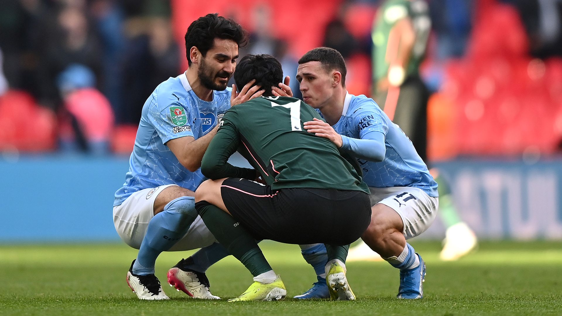 Son Heung-Min of Tottenham Hotspur is consoled by Ilkay Gündogan and Phil Foden of Manchester City after the Carabao Cup final - Credit: Photo by Tottenham Hotspur FC/Tottenham Hotspur FC via Getty Images