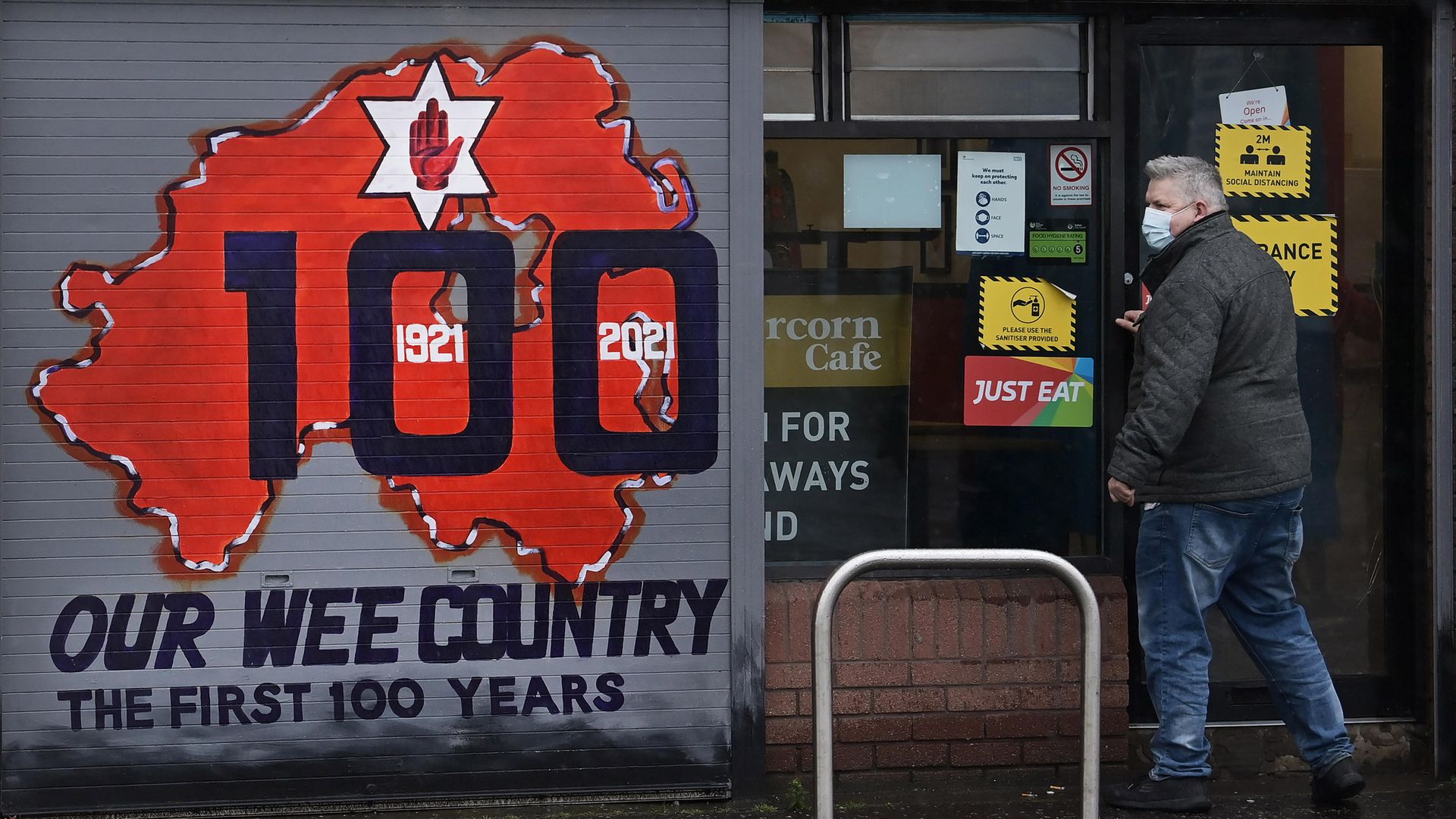 A freshly painted mural on a Belfast shop front marks Northern Ireland's centenary - Credit: Getty Images