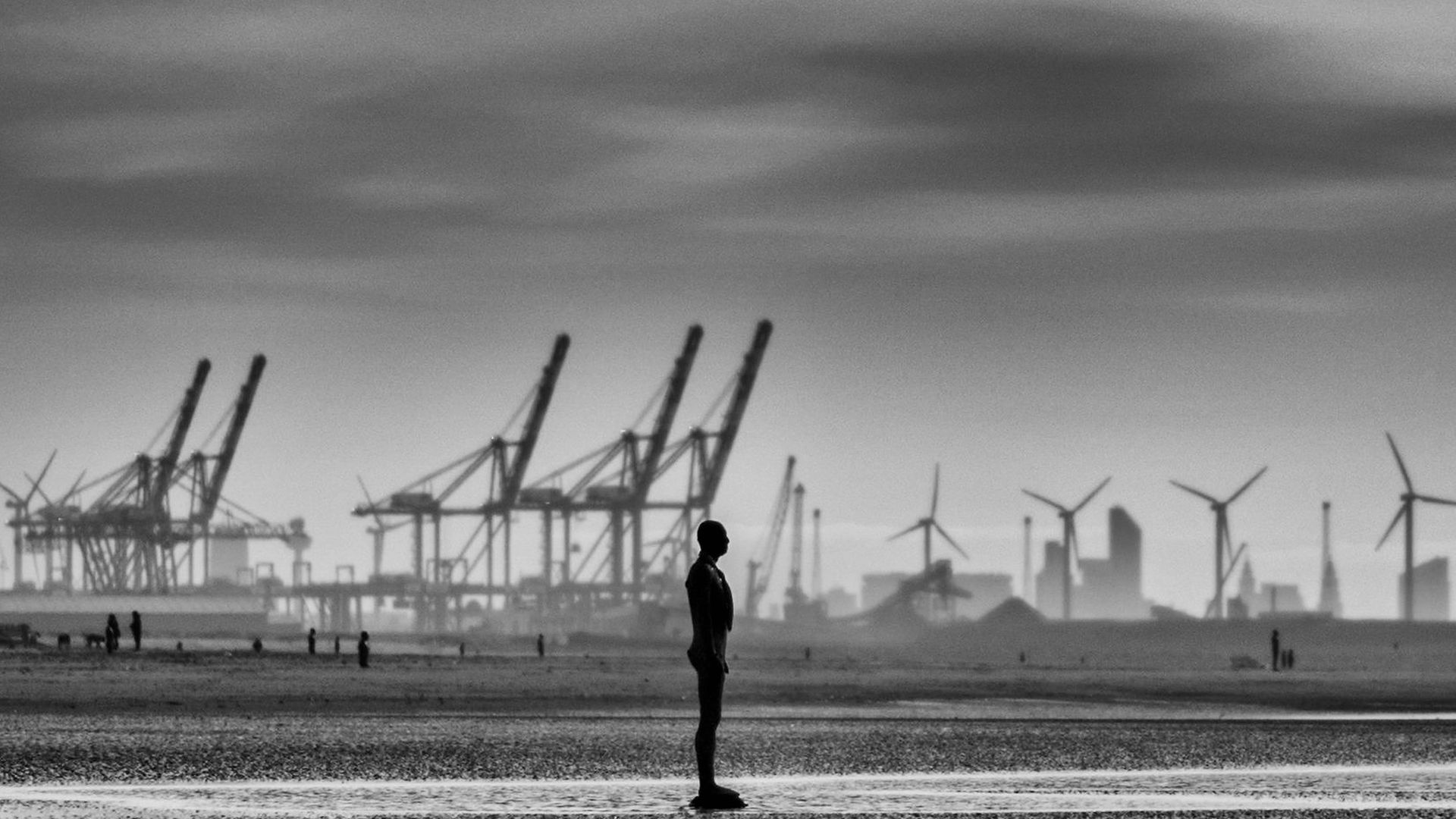 A statue of Antony Gormley's art installation Another Place at Crosby beach - Credit: Getty Images