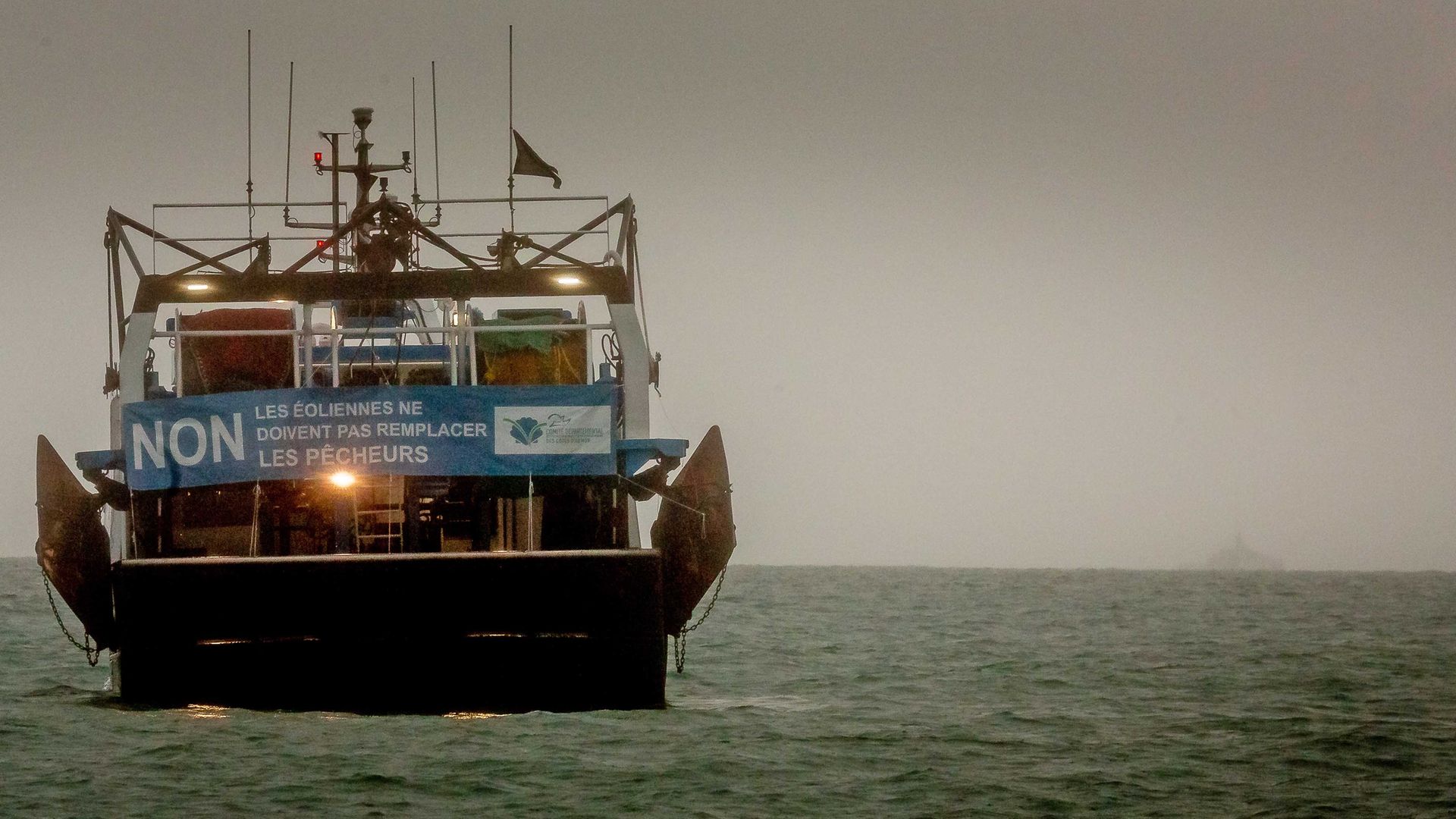 A French fishing boat with a protest sign opposing new fishing licenses in St Helier, Jersey - Credit: Getty Images