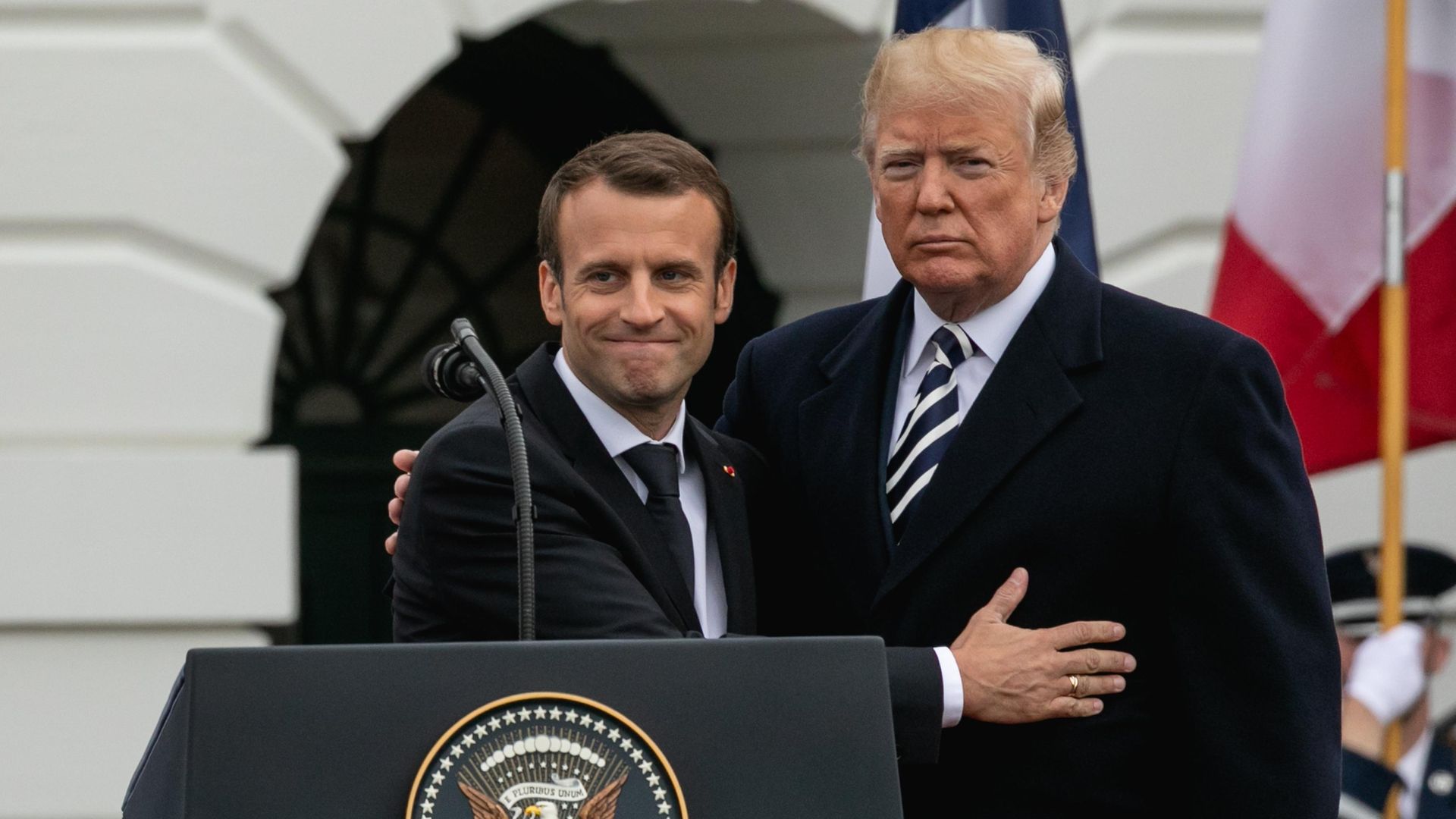 French President Emmanuel Macron and then US President Donald Trump hug - Credit: NurPhoto via Getty Images