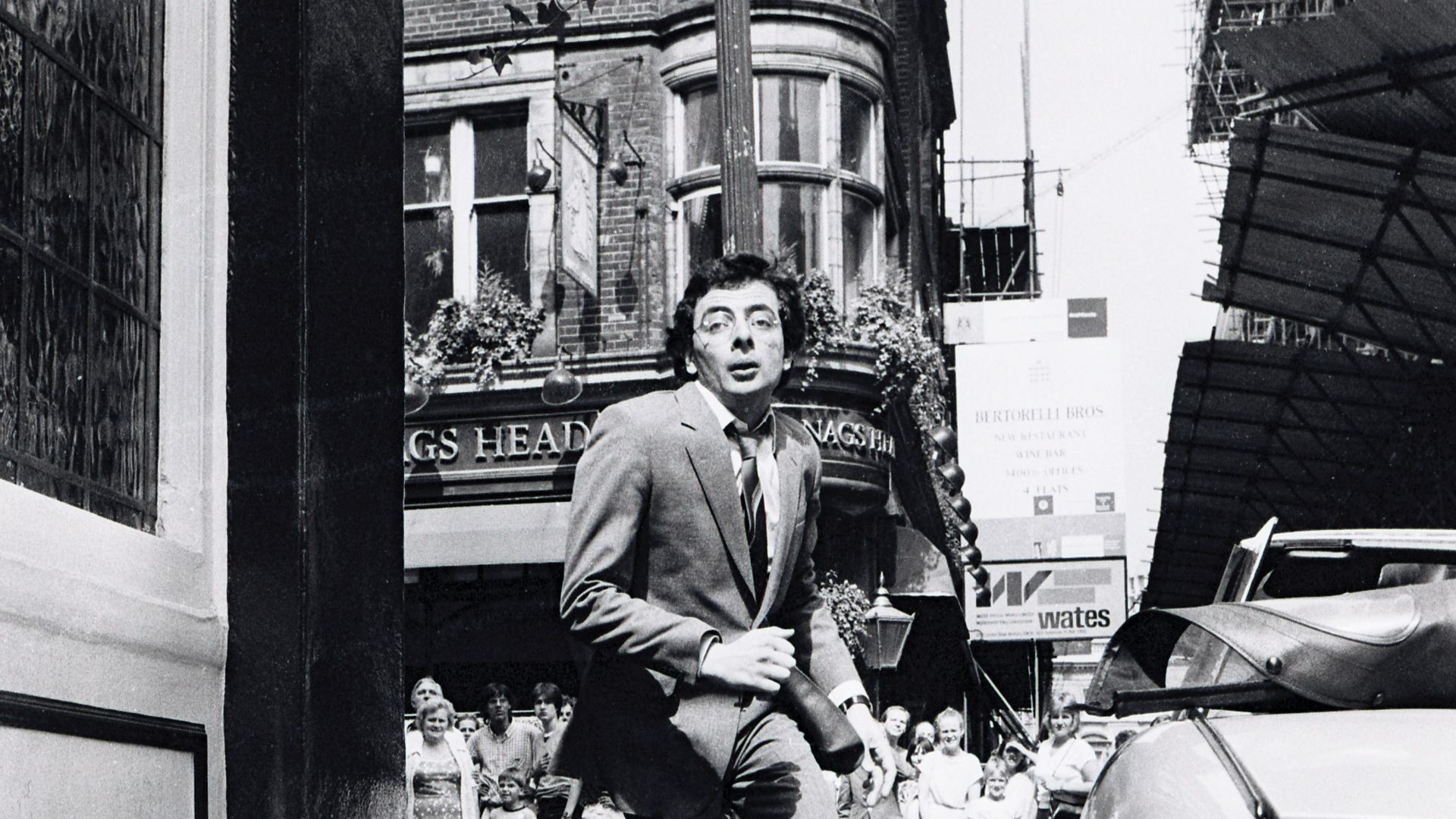 Rowan Atkinson, shooting the 1983 film Dead on Time, in central London: outside the White Lion, Covent Garden - Credit: Getty Images