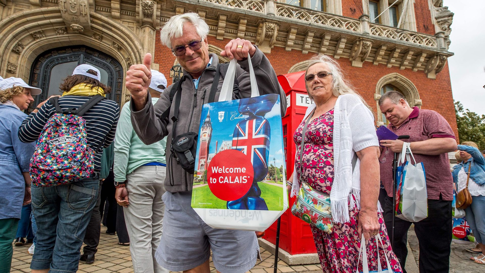 A British tourist poses with a shopping bag at Calais Town Hall - Credit: Photo: Philippe Huguen/AFP via Getty Images