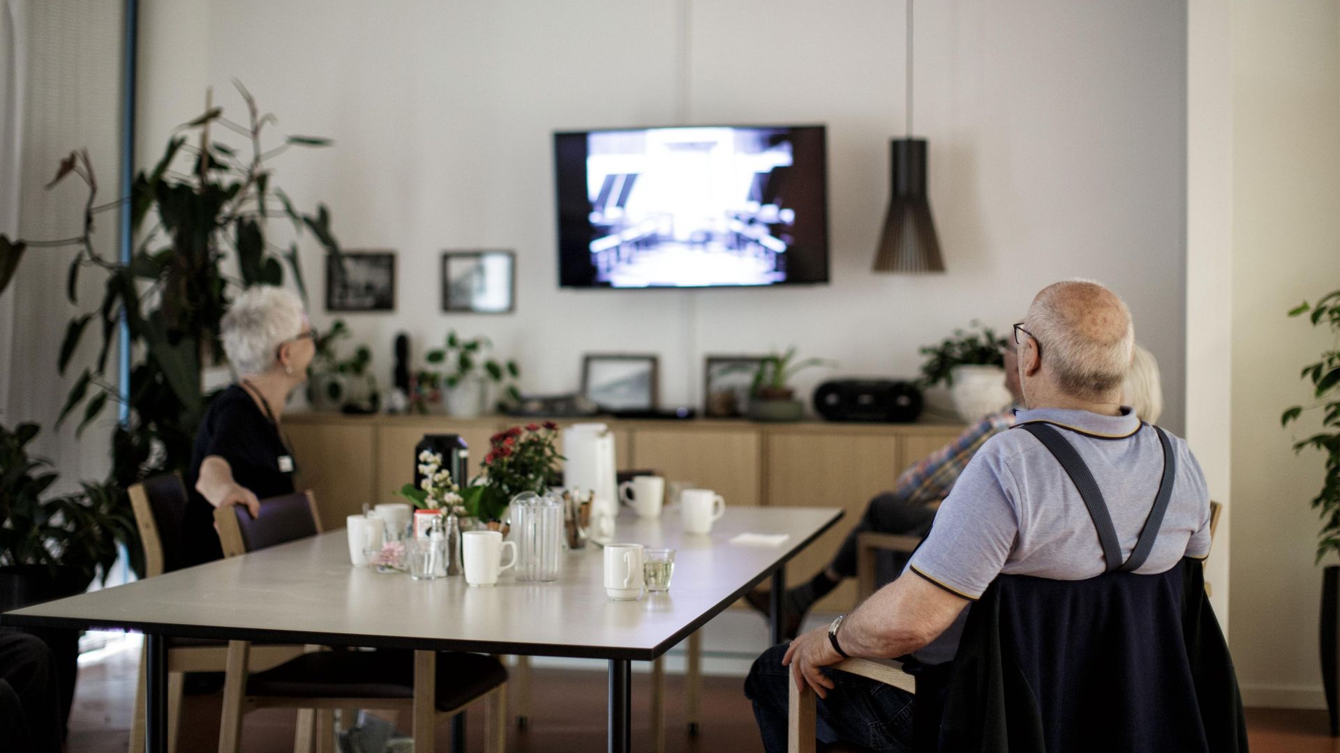 Care home residents watch a movie in Hillerod, near Copenhagen. Denmark has the highest % of GDP spend on social care in Europe. - Credit: AFP via Getty Images