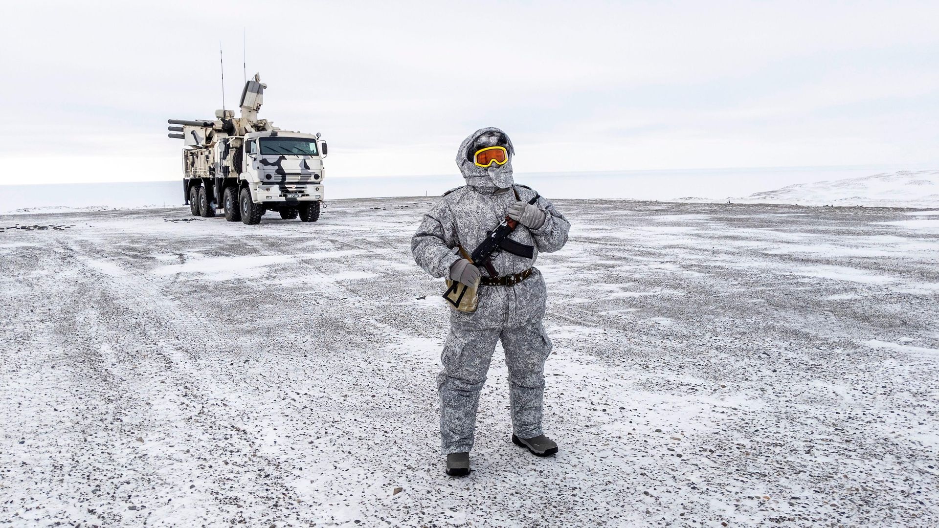 A soldier holds a machine gun as he patrols the Russian northern military base on Kotelny island, beyond the Artic circle - Credit: AFP via Getty Images